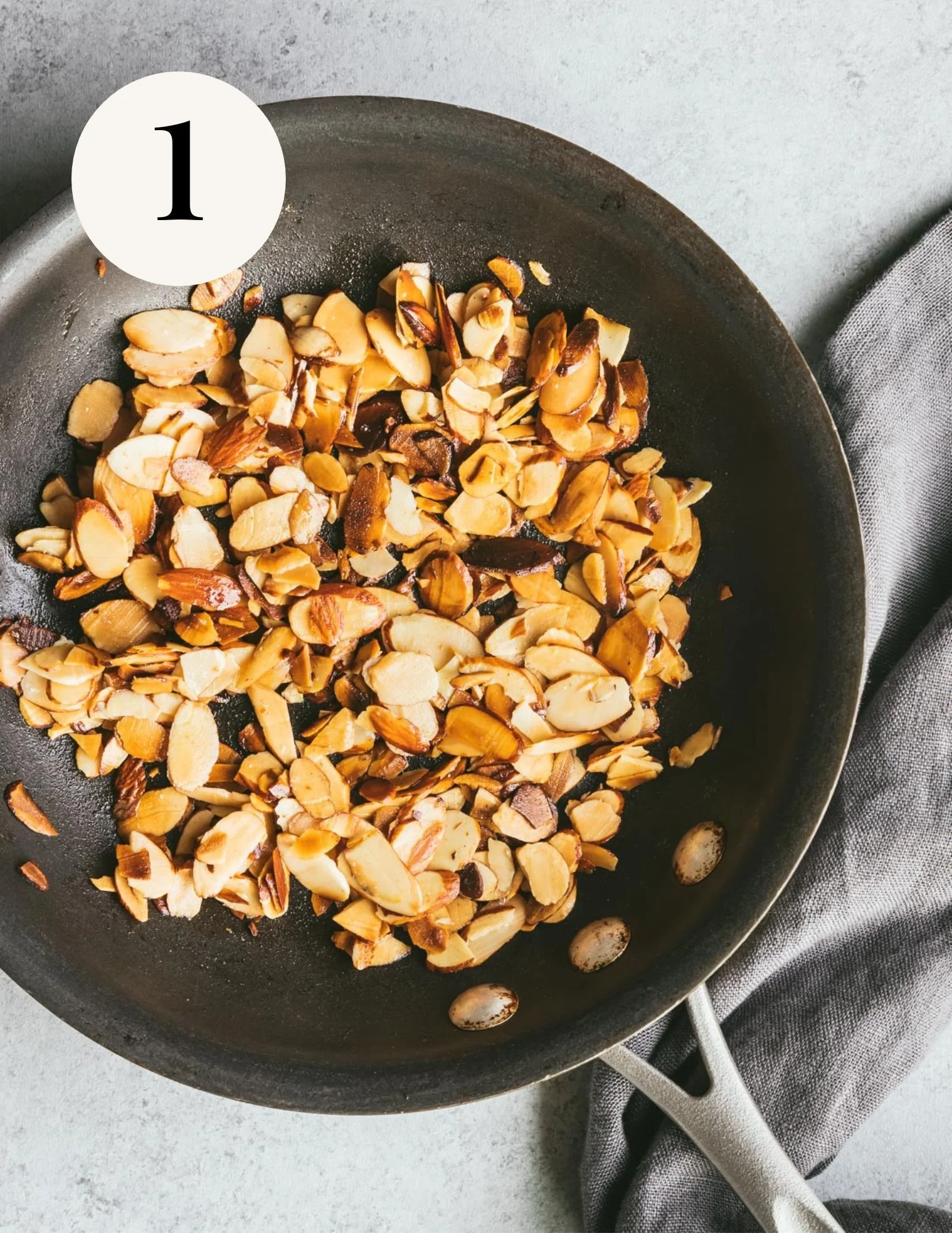 toast sliced almonds in vegan butter