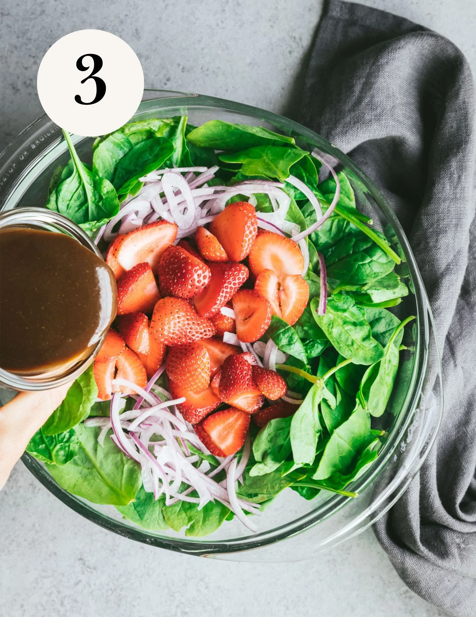 spinach, strawberries, and red onion in a bowl