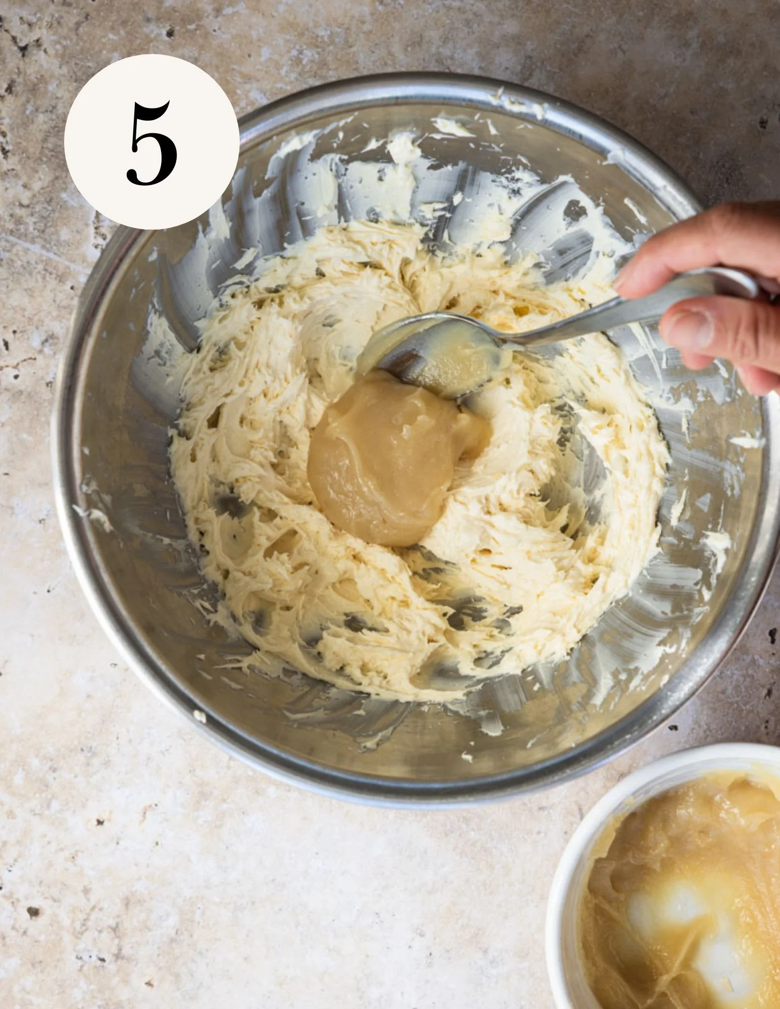 adding the cooked flour mixture one spoonful at a time
