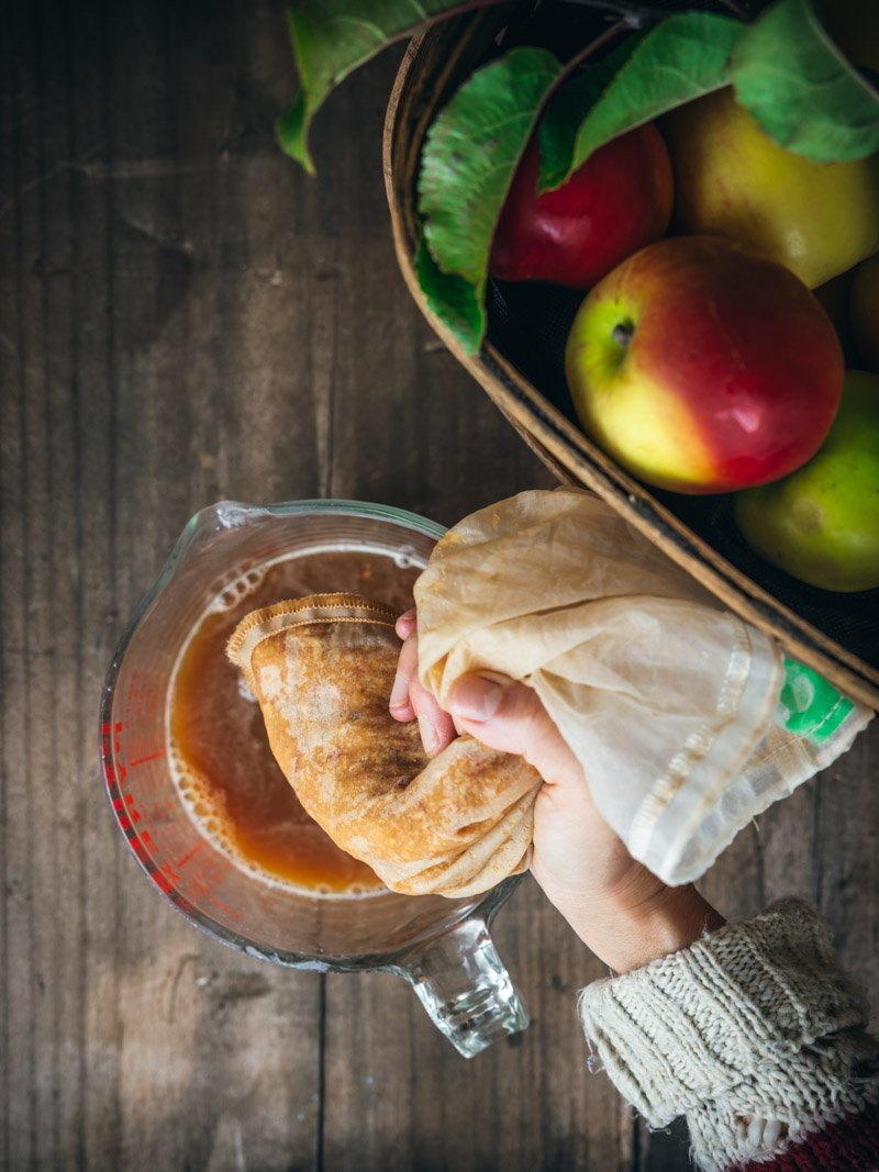 squeezing apple cider from apple pulp