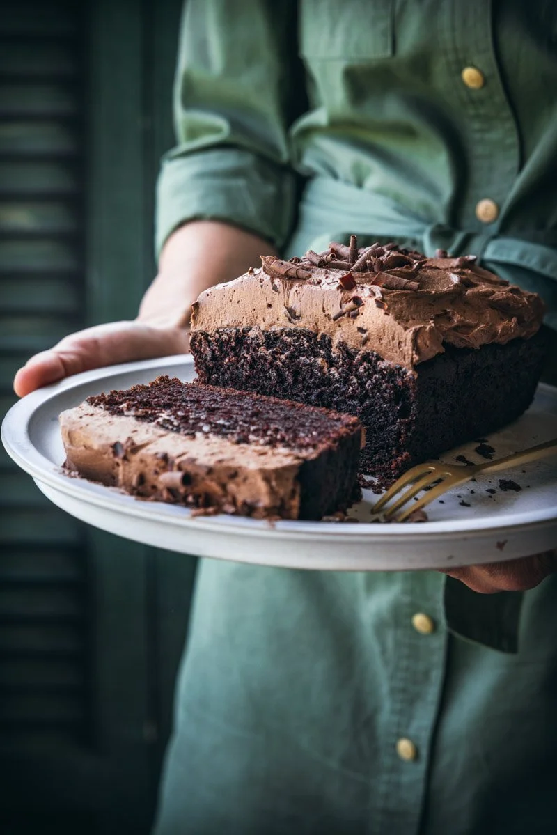 Carol holding a vegan chocolate Guinness cake with chocolate ermine frosting