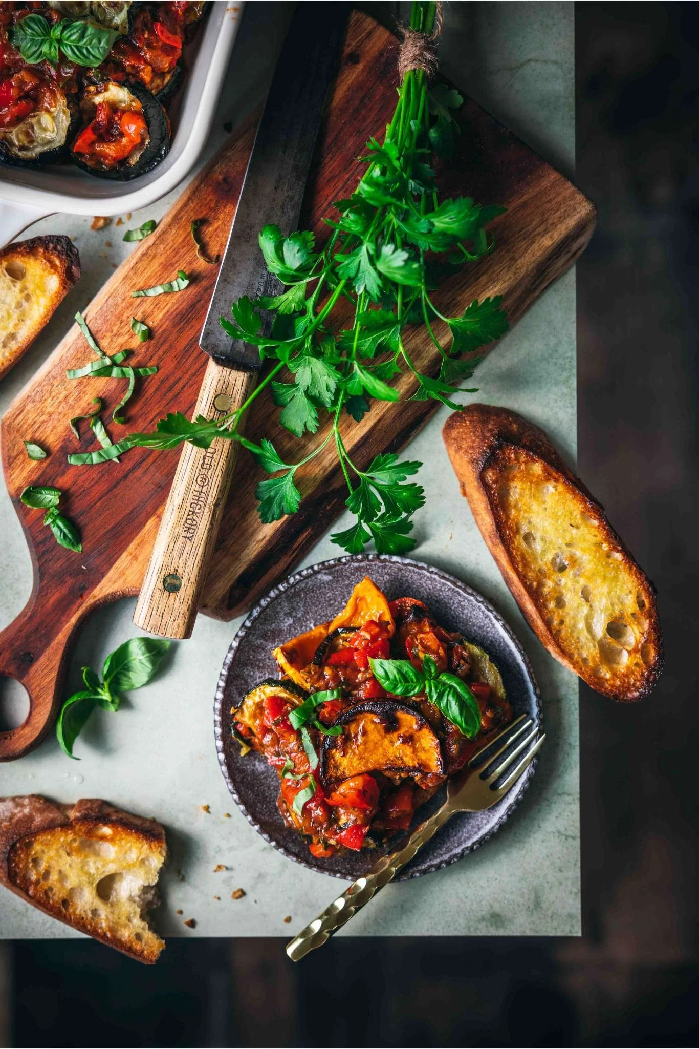 vegan ratatouille served on a plate with toasted baguette