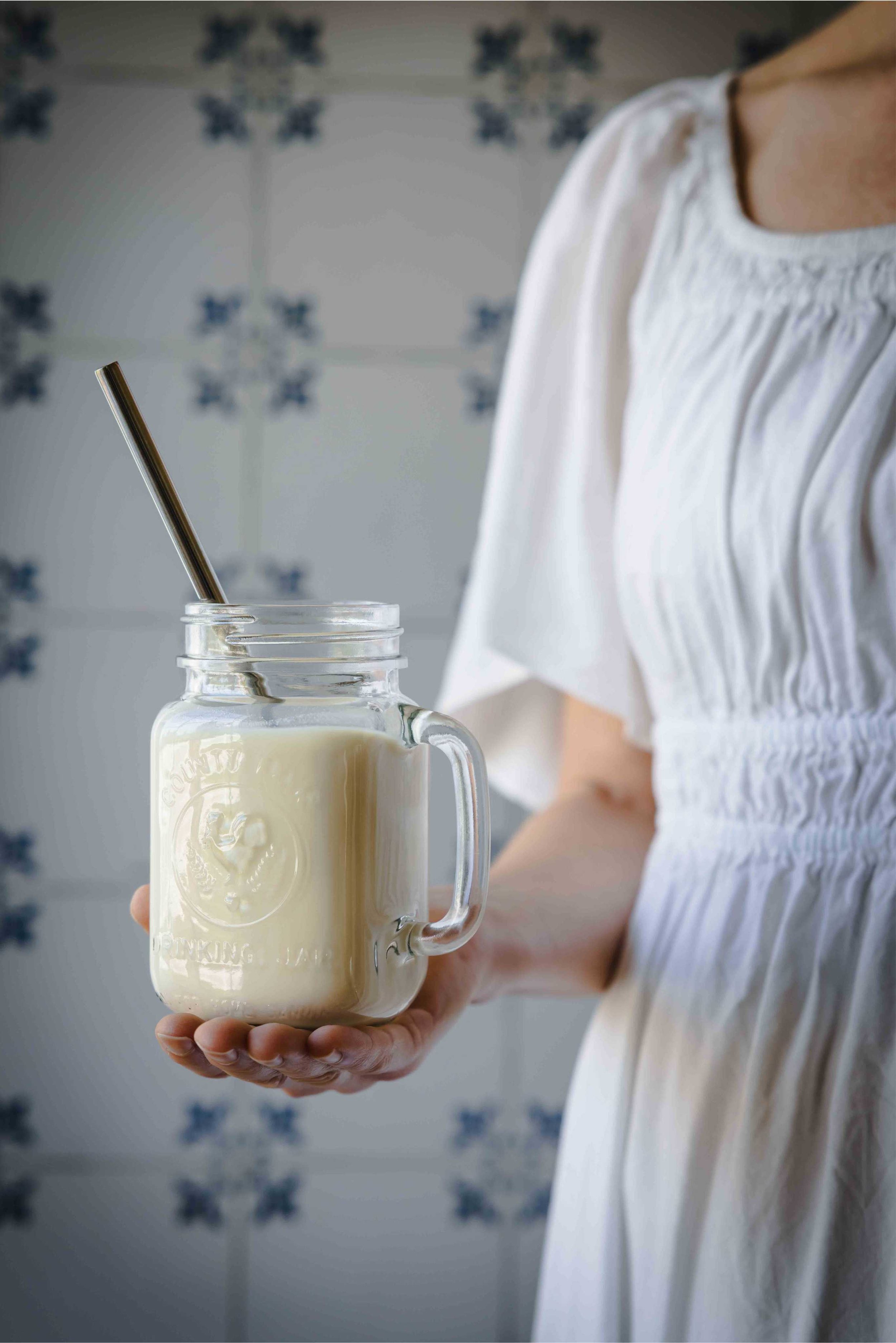 Carol holding a glass of homemade soy milk