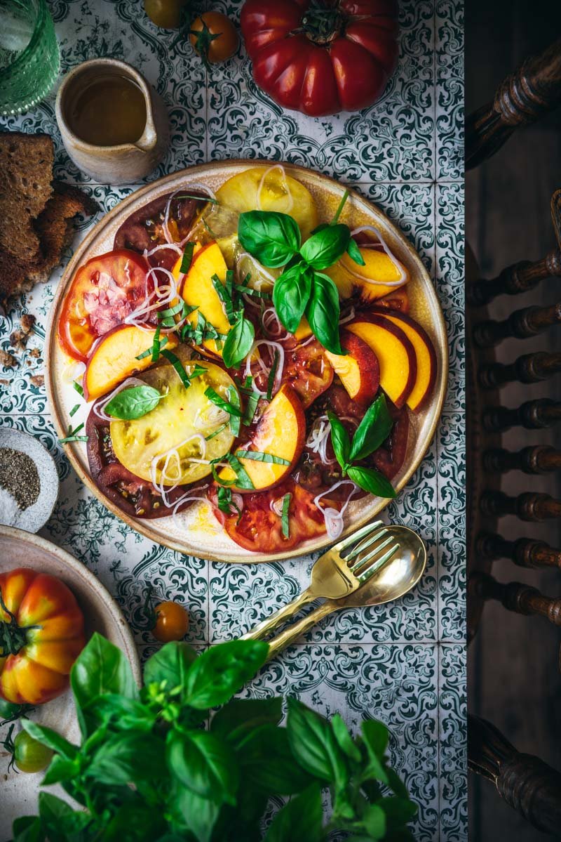 tomato crudo with stone fruit served on a platter