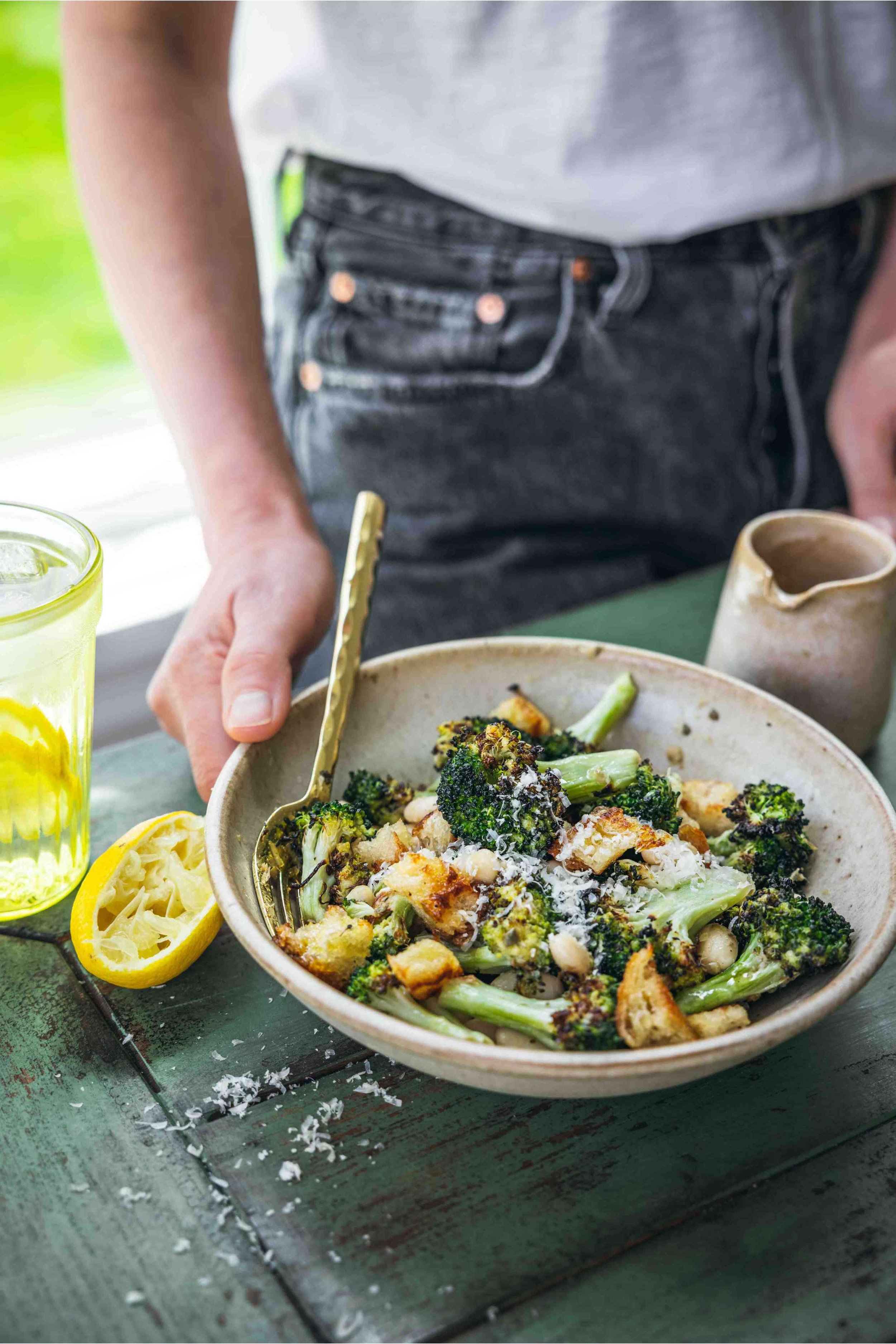 Carol with a bowl of roasted broccoli caesar salad with vegan dressing