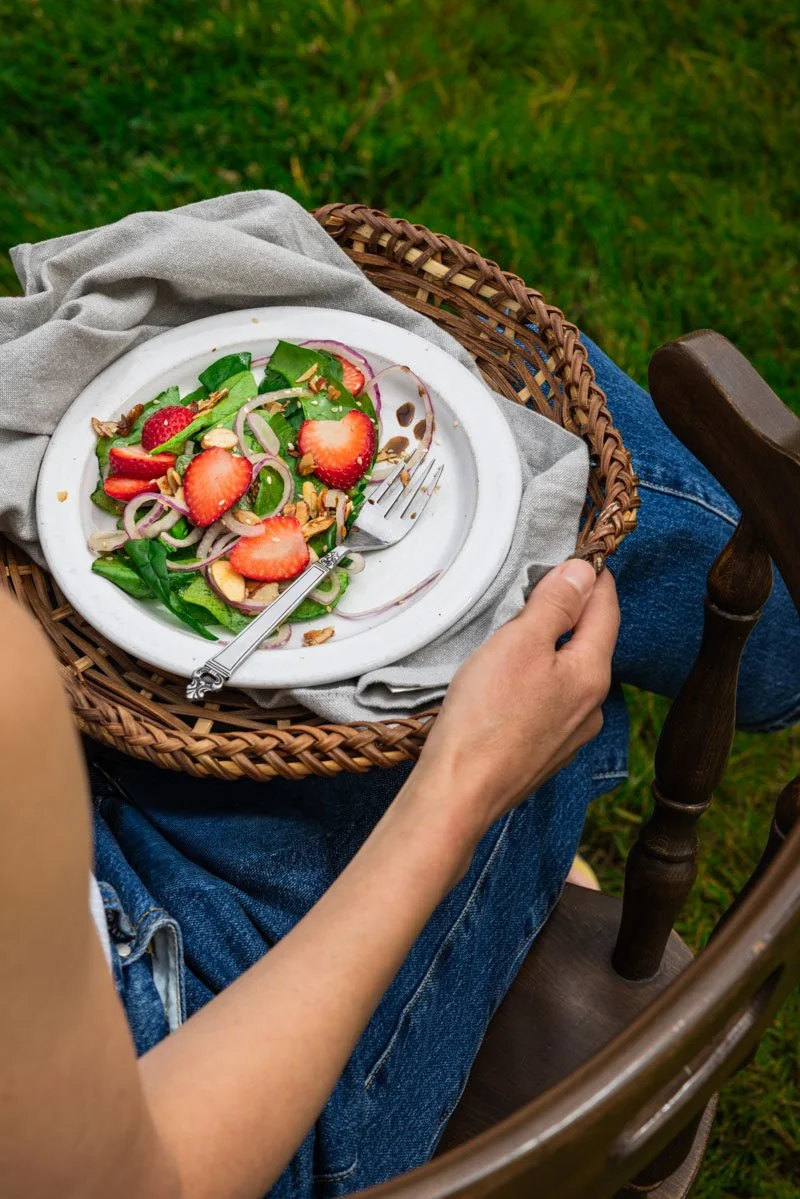 Carol outside with a vegan spinach salad