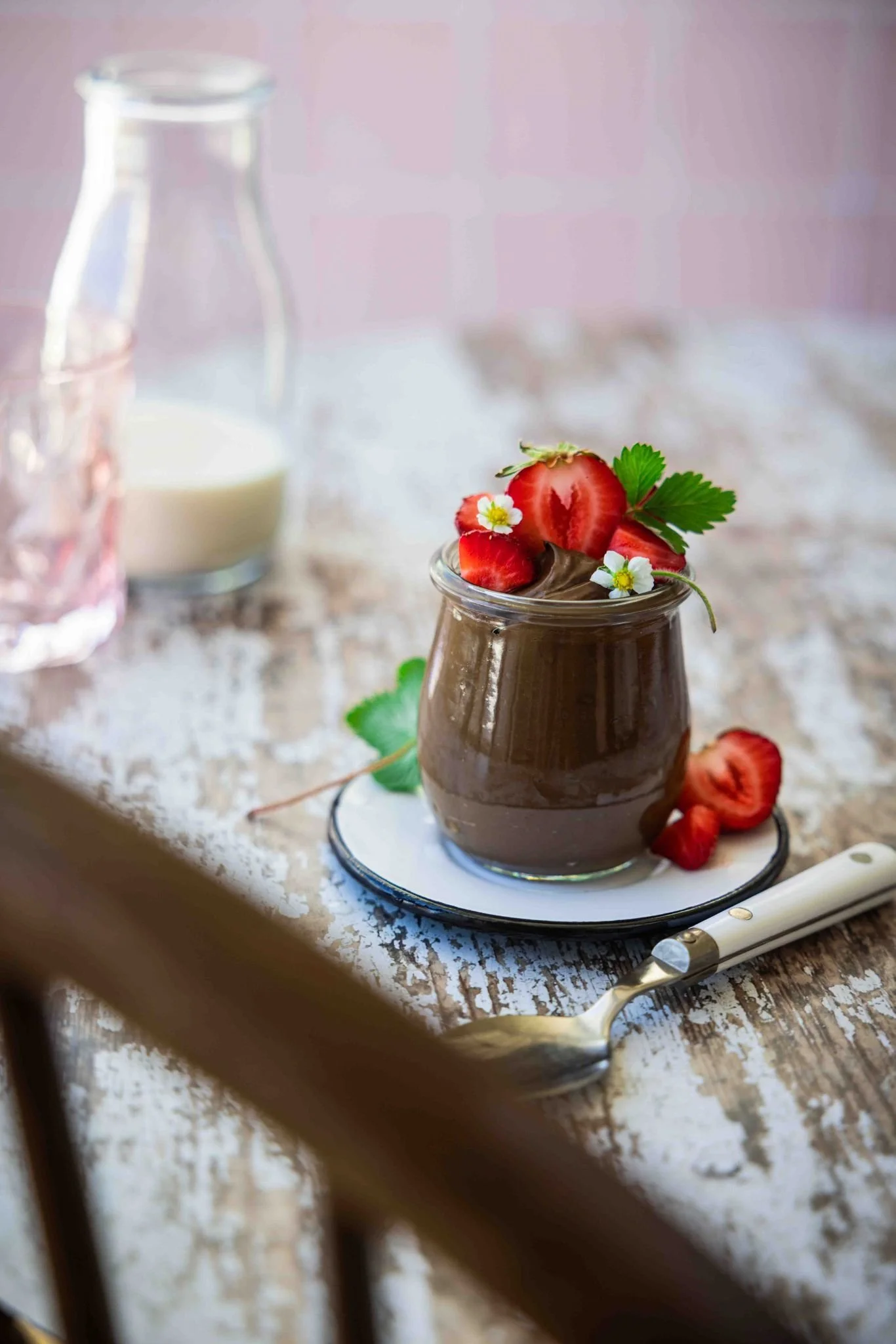 vegan avocado chocolate mousse in a jar with berries on top