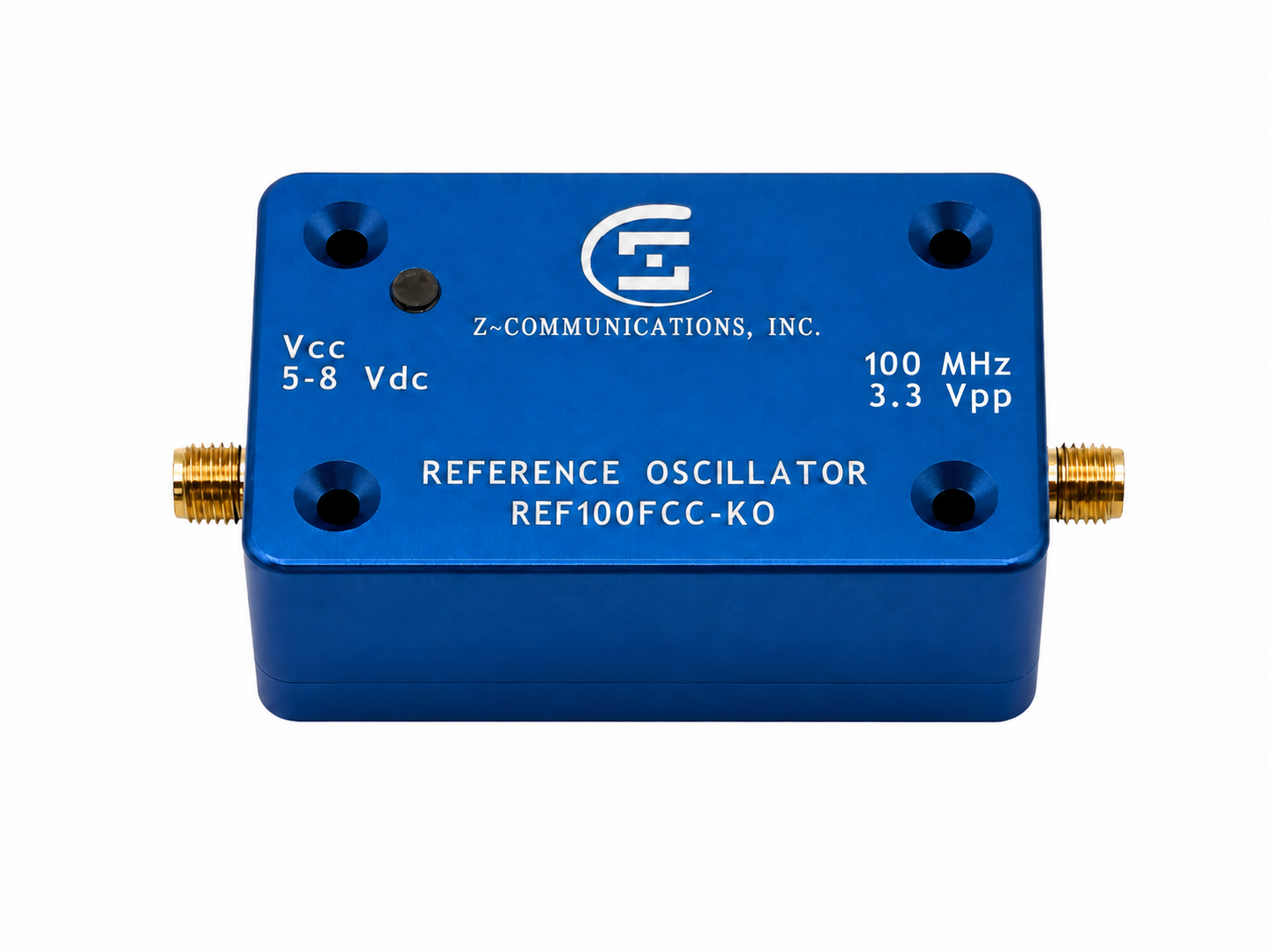 Z-Communications REF100FCC-KO 100 MHz CMOS OCXO reference, labeled 5–8 Vdc and 3.3 Vpp, in a blue metal enclosure