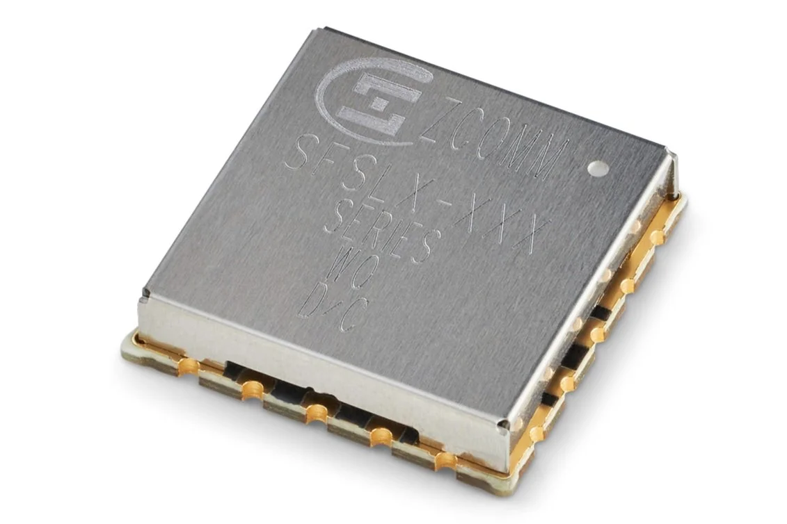 A microchip with markings including 'Intel' and 'ZCOMM', resting on a white surface.