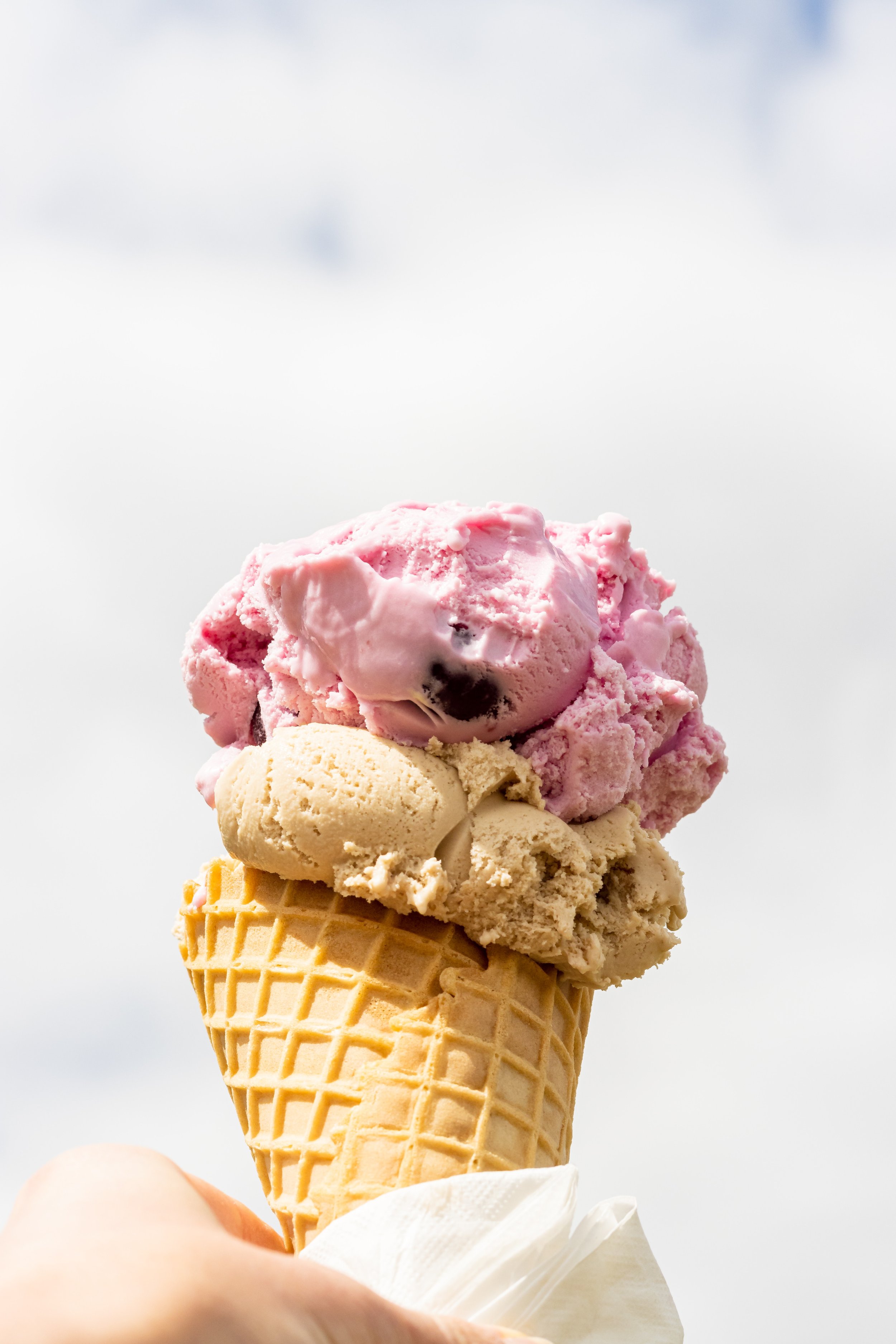 Pink and cream icecream in an icecream cone