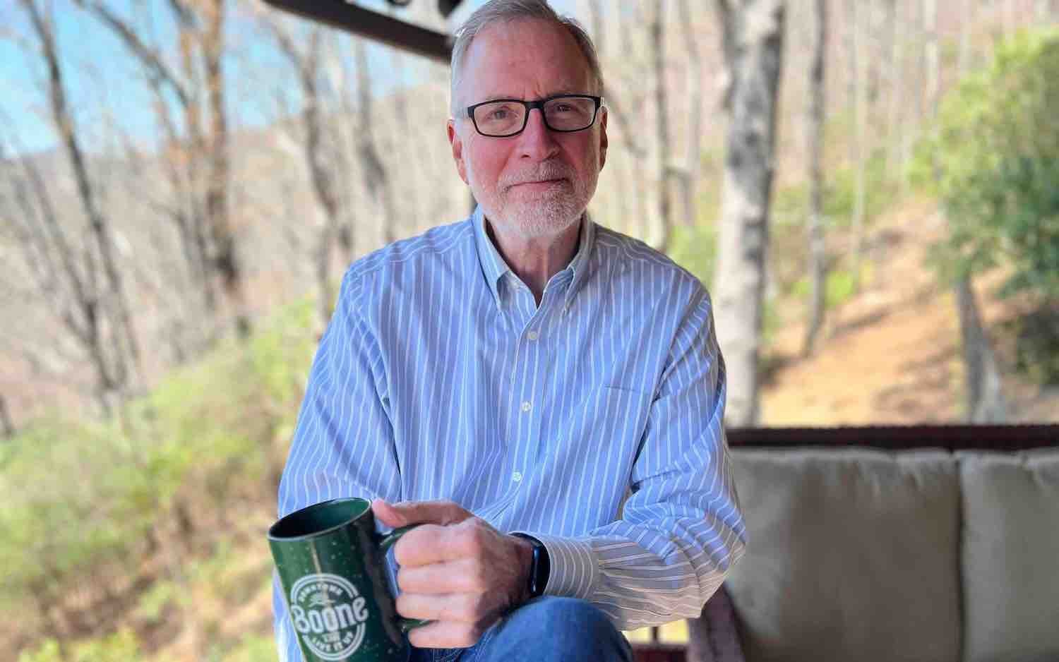 Bert, owner of BigMacDaddy Design sitting on back porch with a cup of coffee.