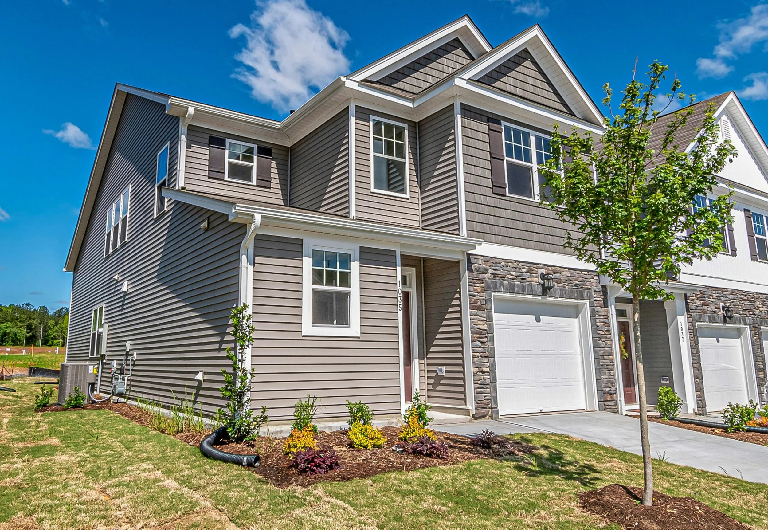 Houston TX investment property townhome with attached garage and landscaped front yard