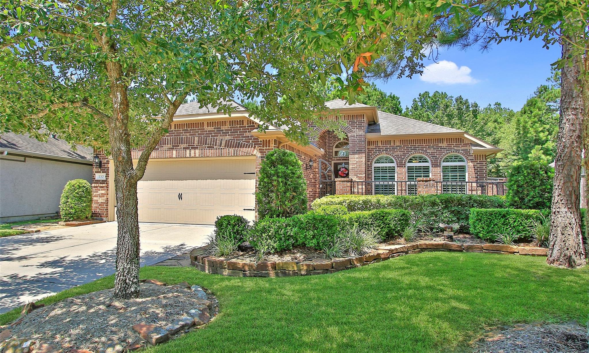 Brick patio home in a Greater Houston area 55 plus community with manicured lawn and low maintenance landscaping