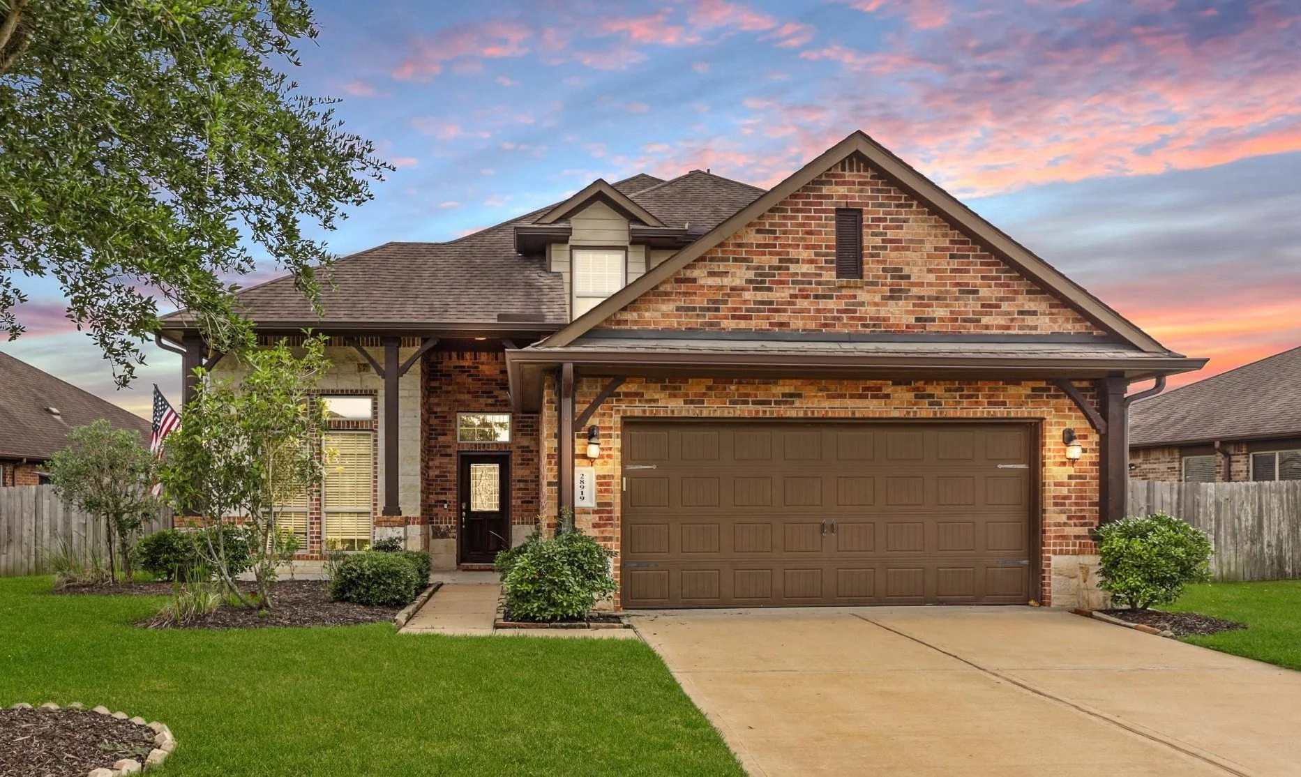 Houston Texas first time homebuyer home with brick exterior, two car garage, and landscaped front yard