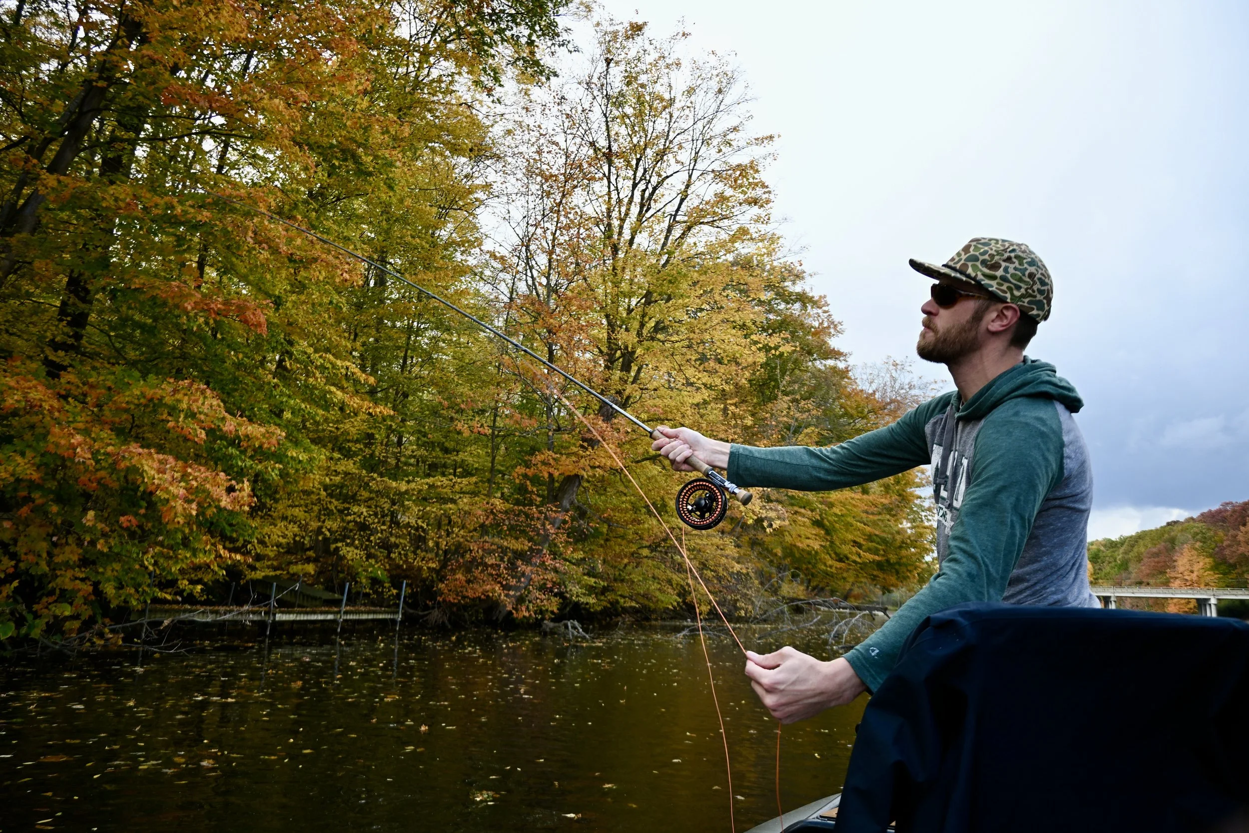 Man casting a fly rod on a river in West Michigan near Grand Rapids, Michigan