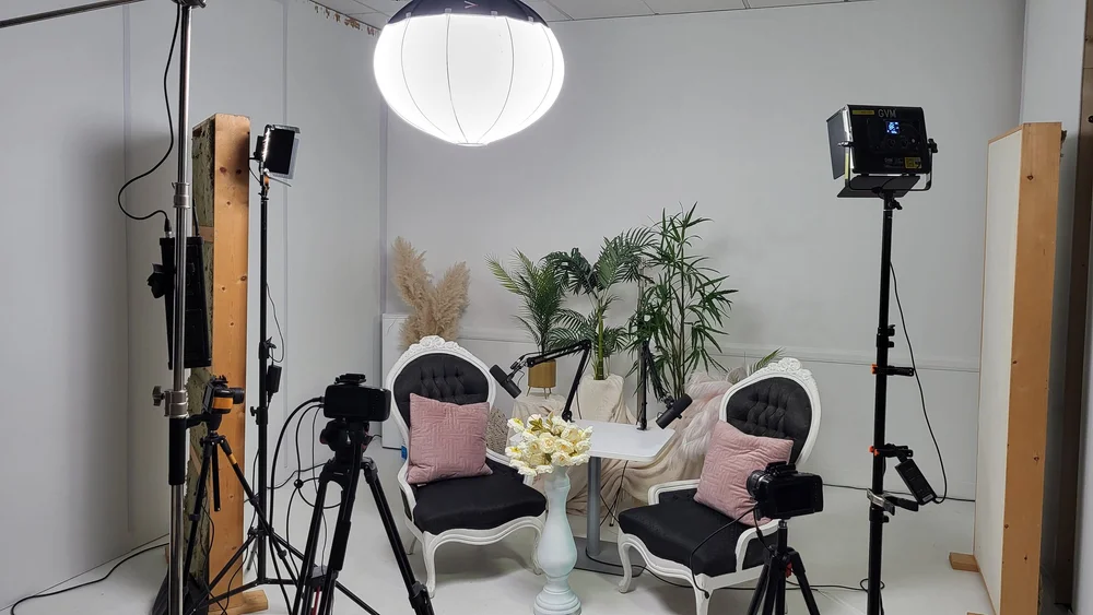 Two chairs, lights and cameras set up for a talk in the Dream Lounge