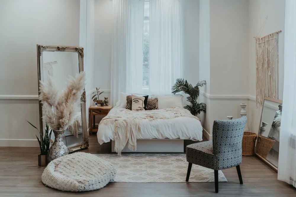 A styled boudoir set in the Dream Lounge, with a bed, mirror and soft window light