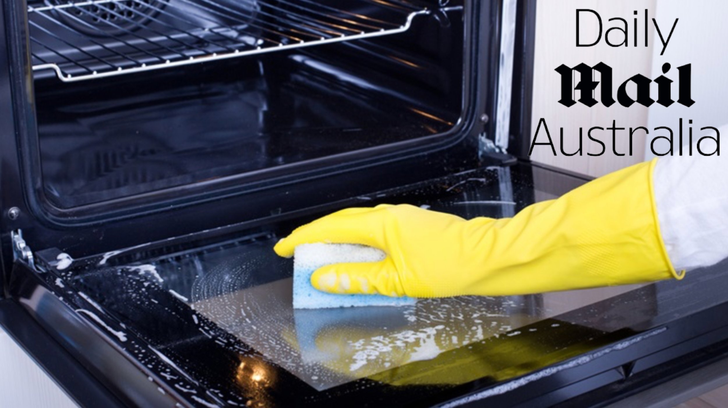 person deep cleaning oven
