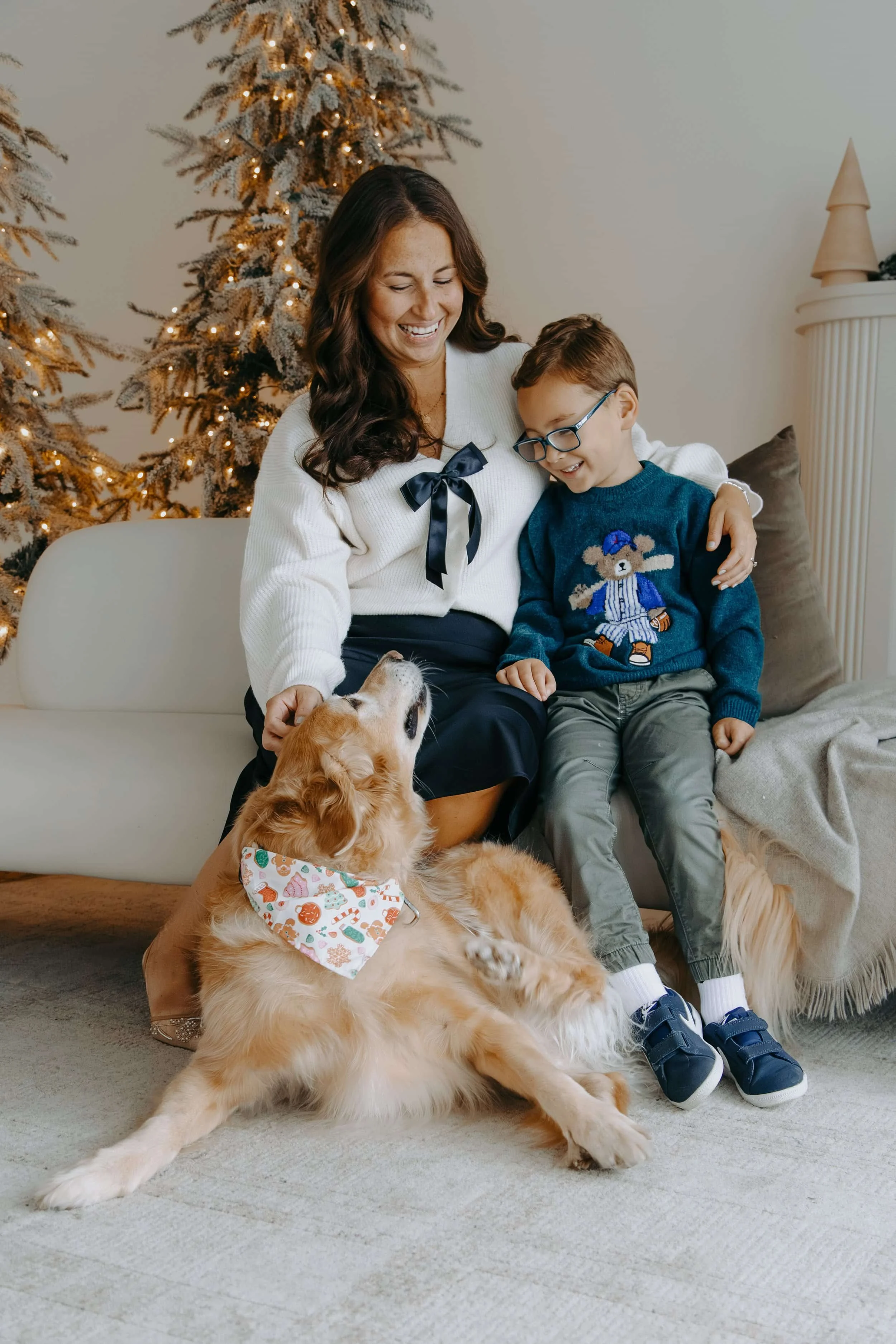 Woman with son and family dog in a holiday studio setting.