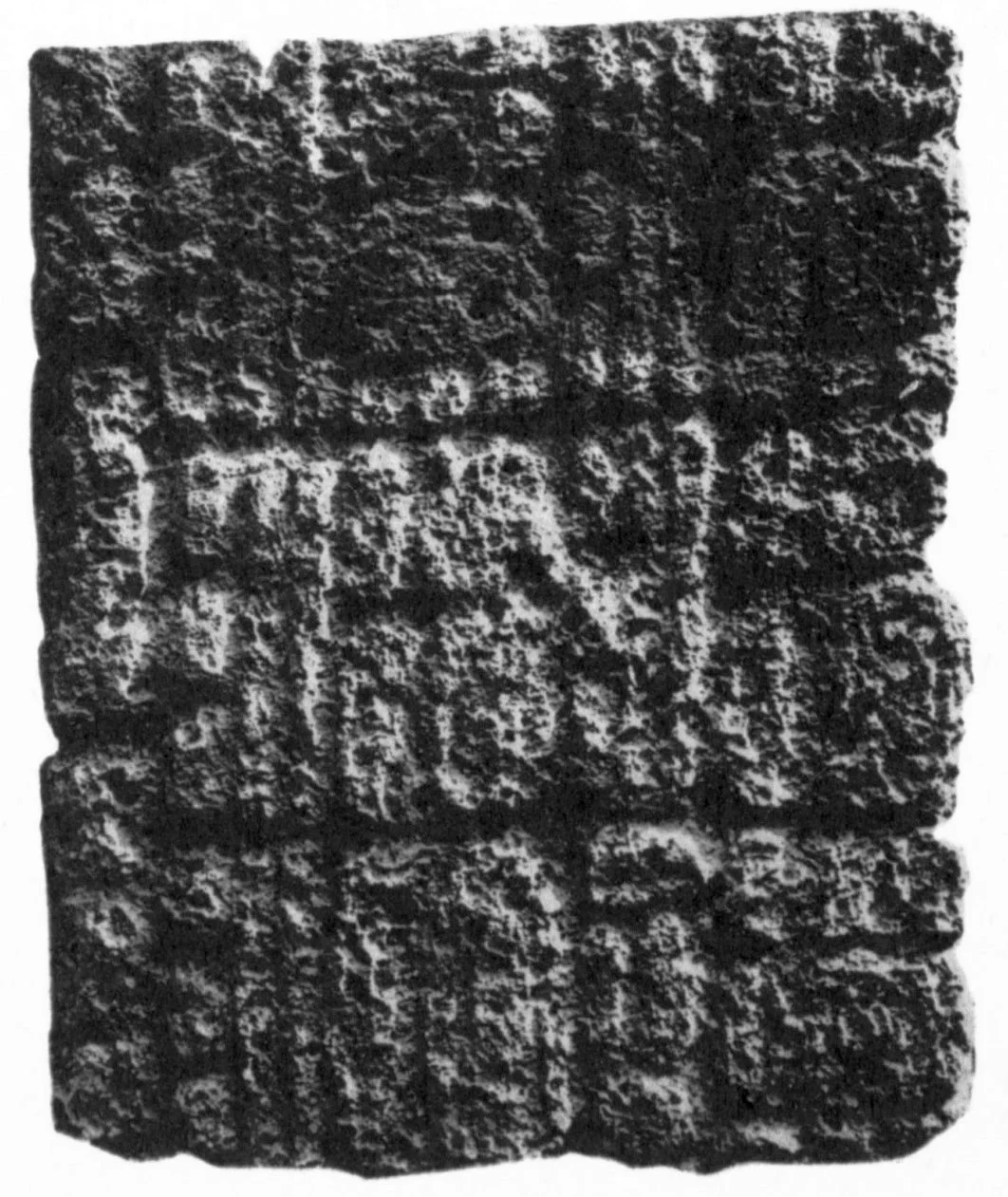 Weathered Maya stone stela with carved glyphs at Cobá, Mexico.