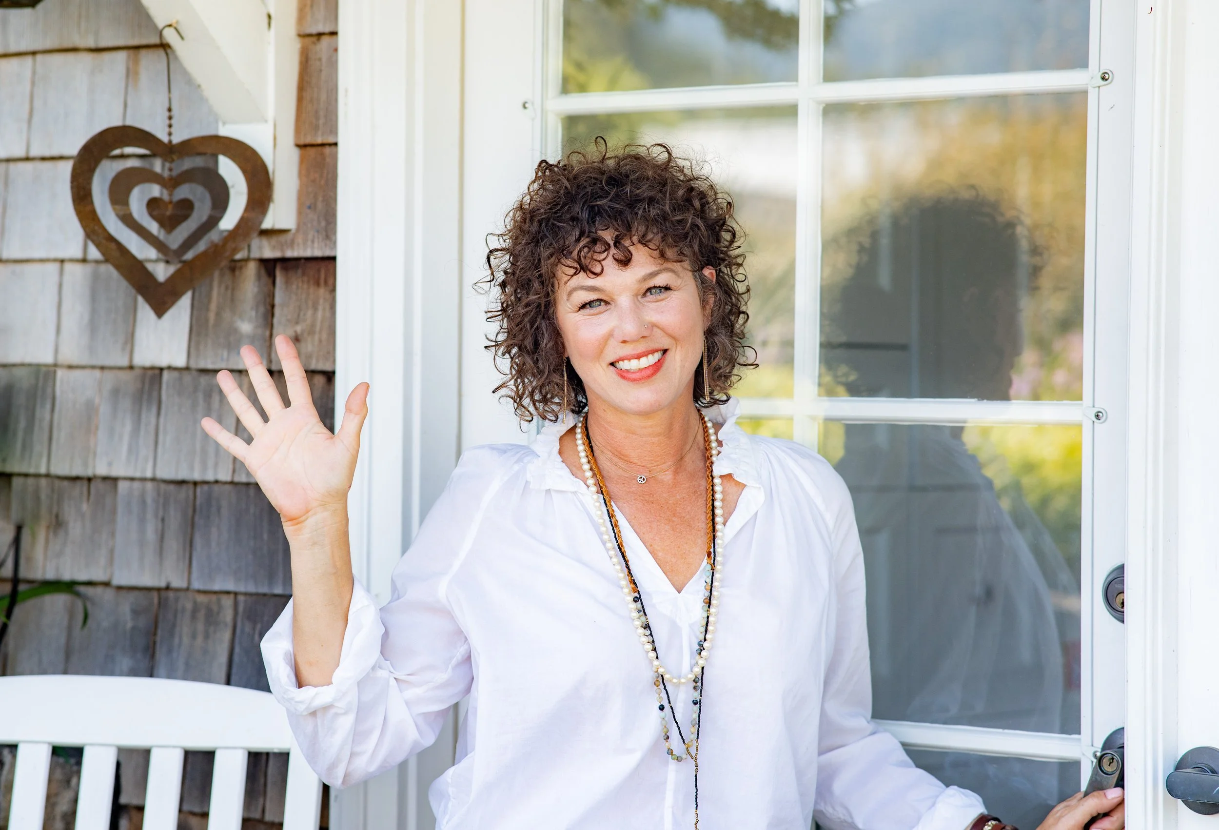 Woman business owner and author smiling in her front yard, during a branding photography session in Marin County