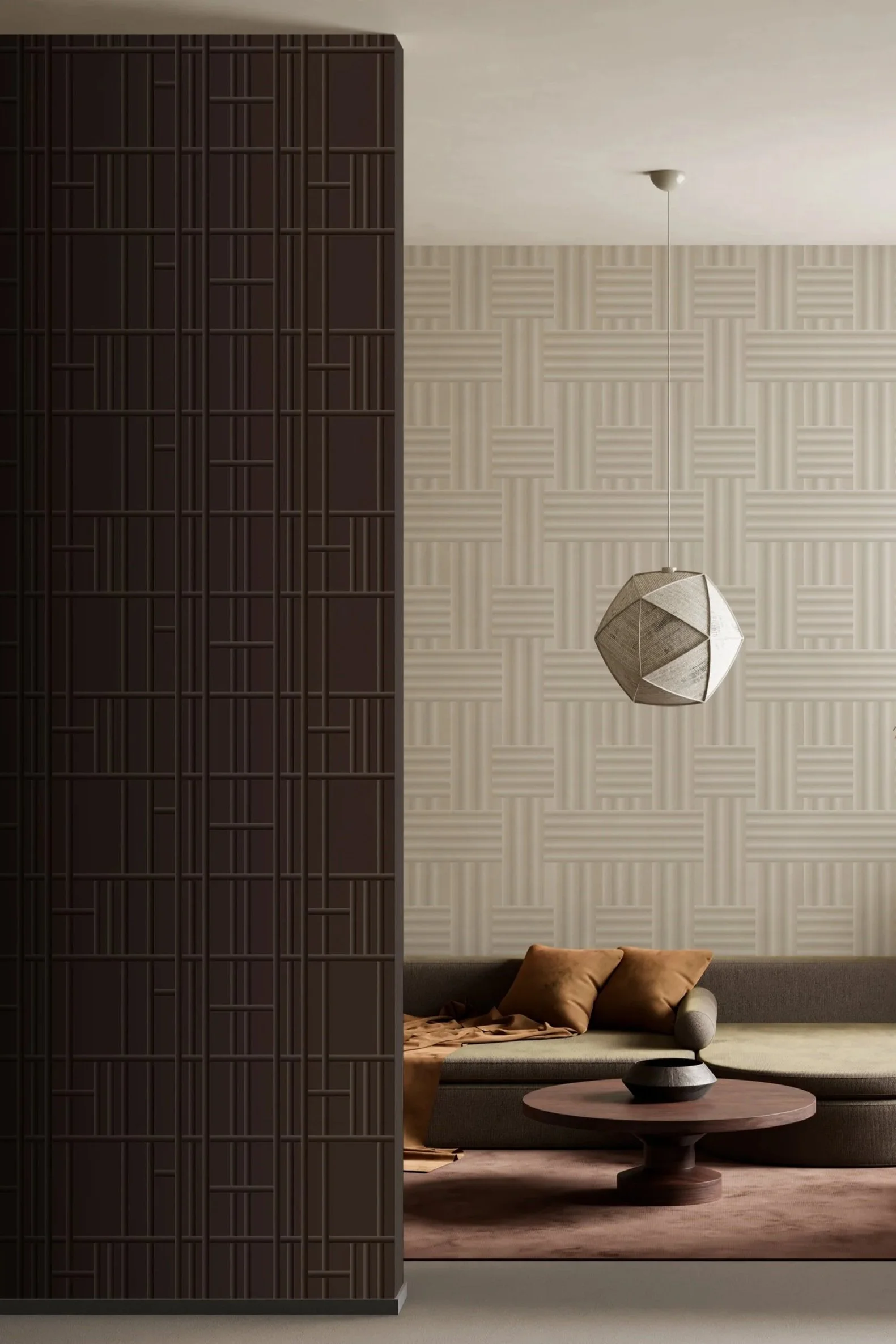 Modern living room with a dark brown textured partition, beige geometric patterned wallpaper, a gray sectional sofa with brown pillows, a round wooden coffee table, and a unique geometrical pendant light.