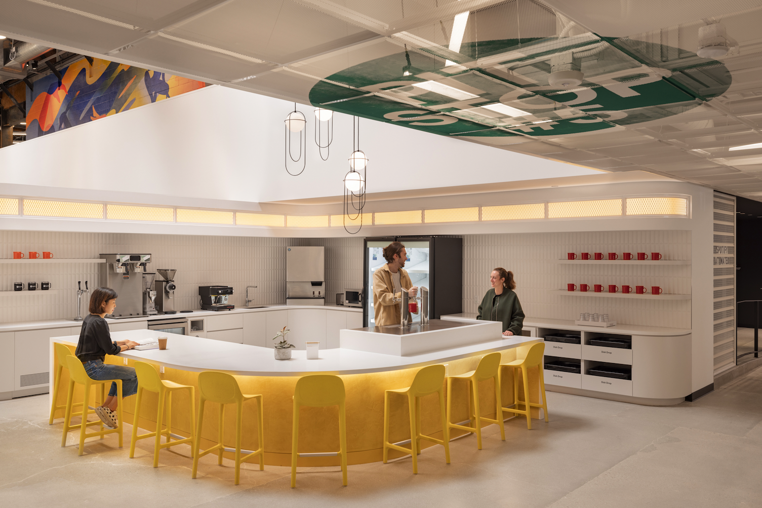 Ceiling graphics create a subtle wayfinding moment and reinforce space identity