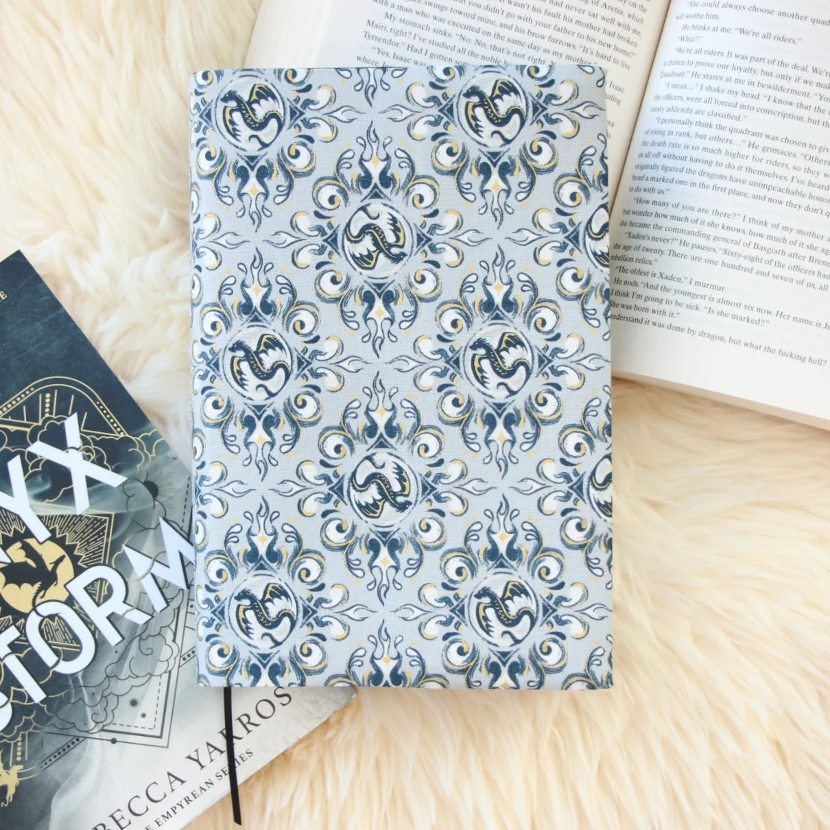 Handmade adjustable fabric First Edition book jacket protecting a hardcover book with dragon-inspired fabric.