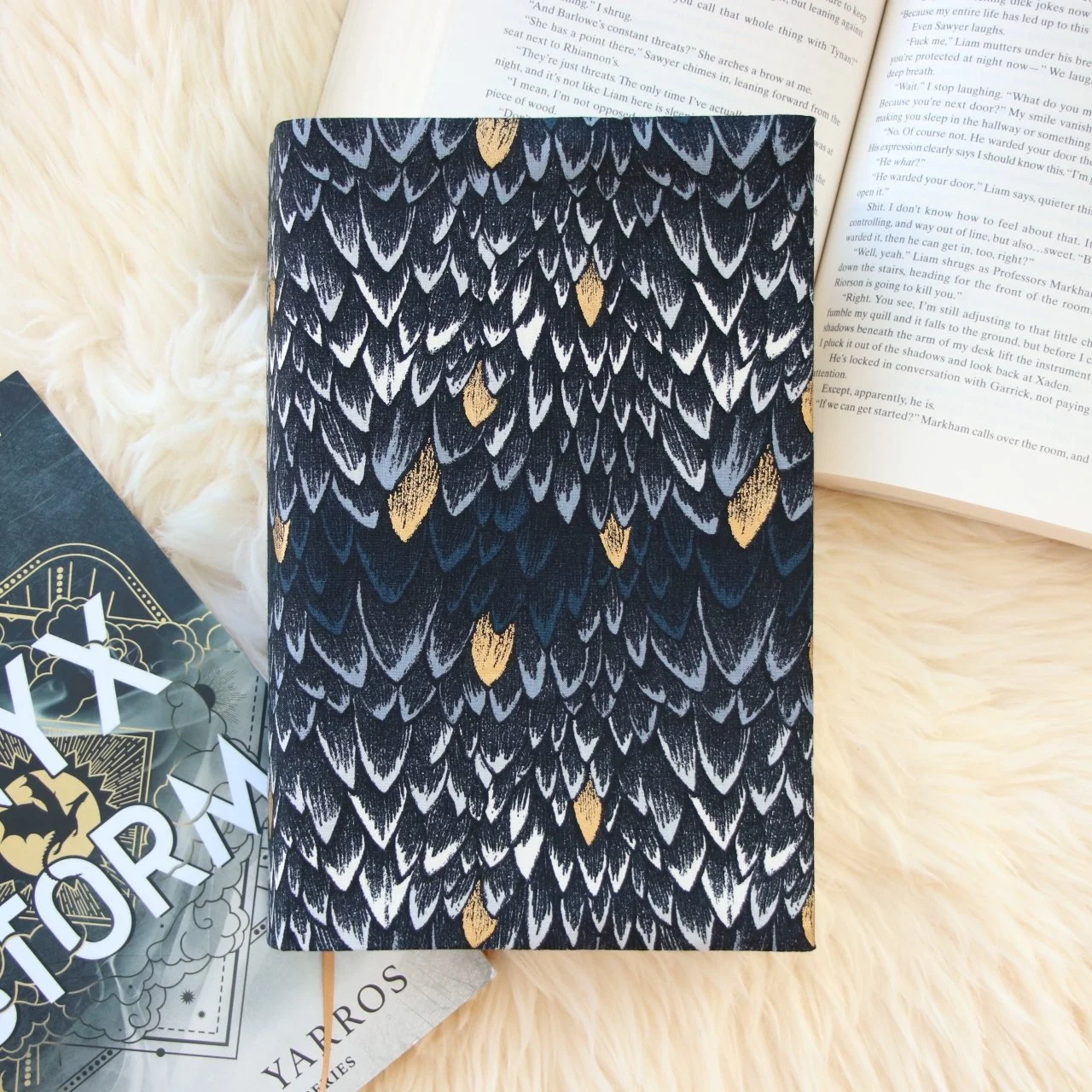 Handmade adjustable fabric First Edition book jacket protecting a hardcover book with dragon-inspired fabric.