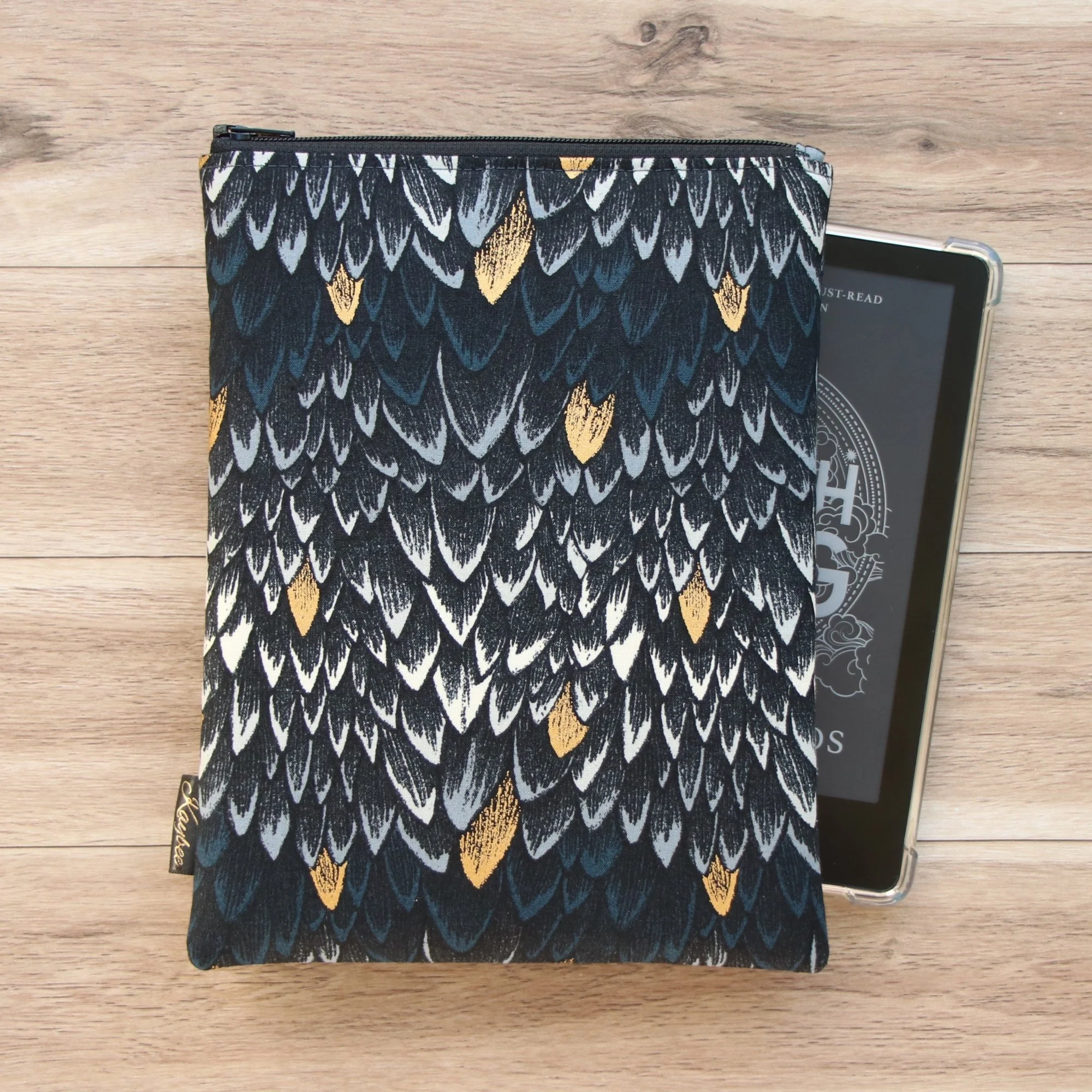 The First Edition Kindle Sleeve handmade in New Zealand featuring premium dragon-scale fabric, foam padding and a YKK zipper.