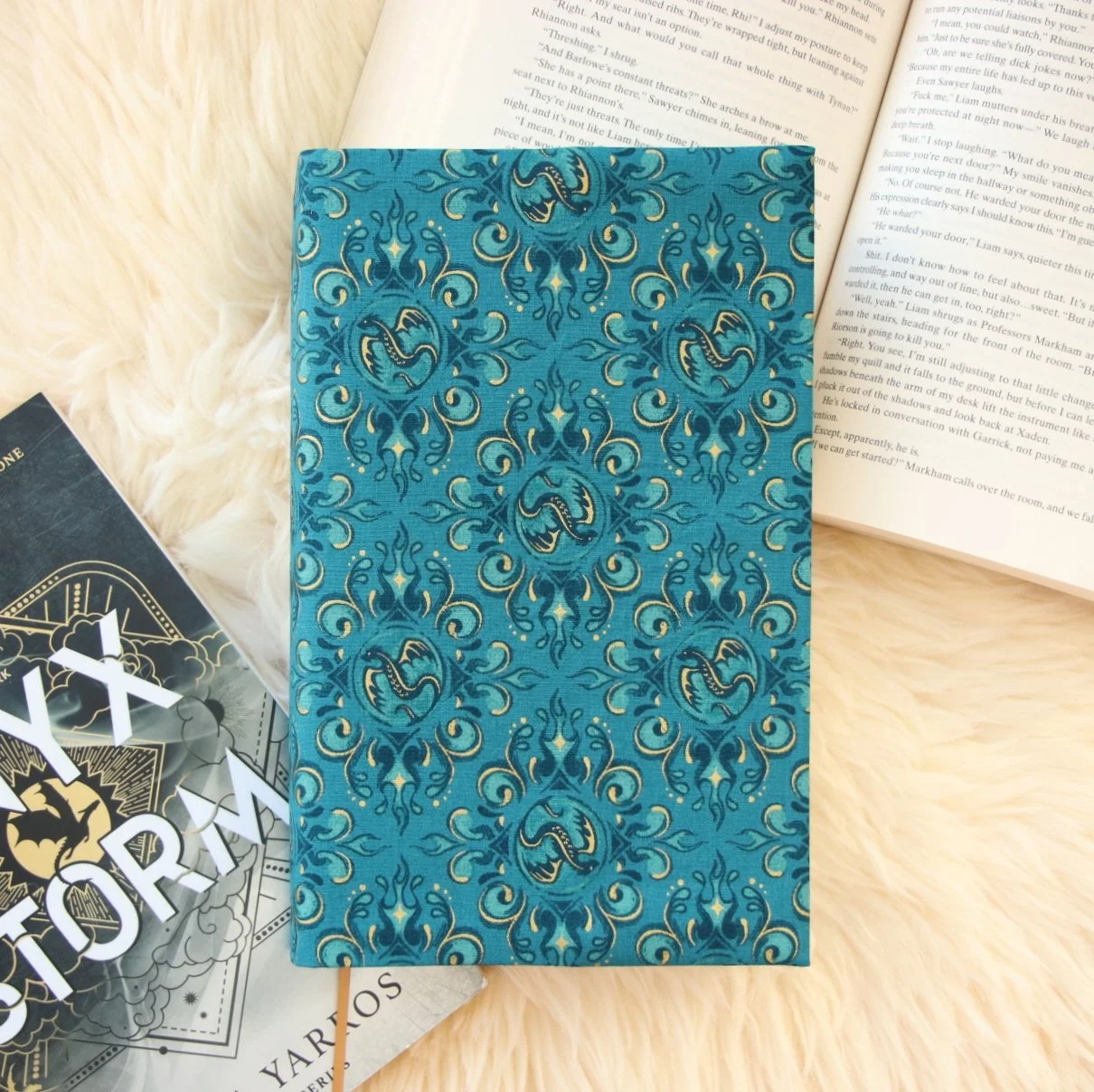 Handmade adjustable fabric First Edition book jacket protecting a hardcover book with dragon-inspired fabric.