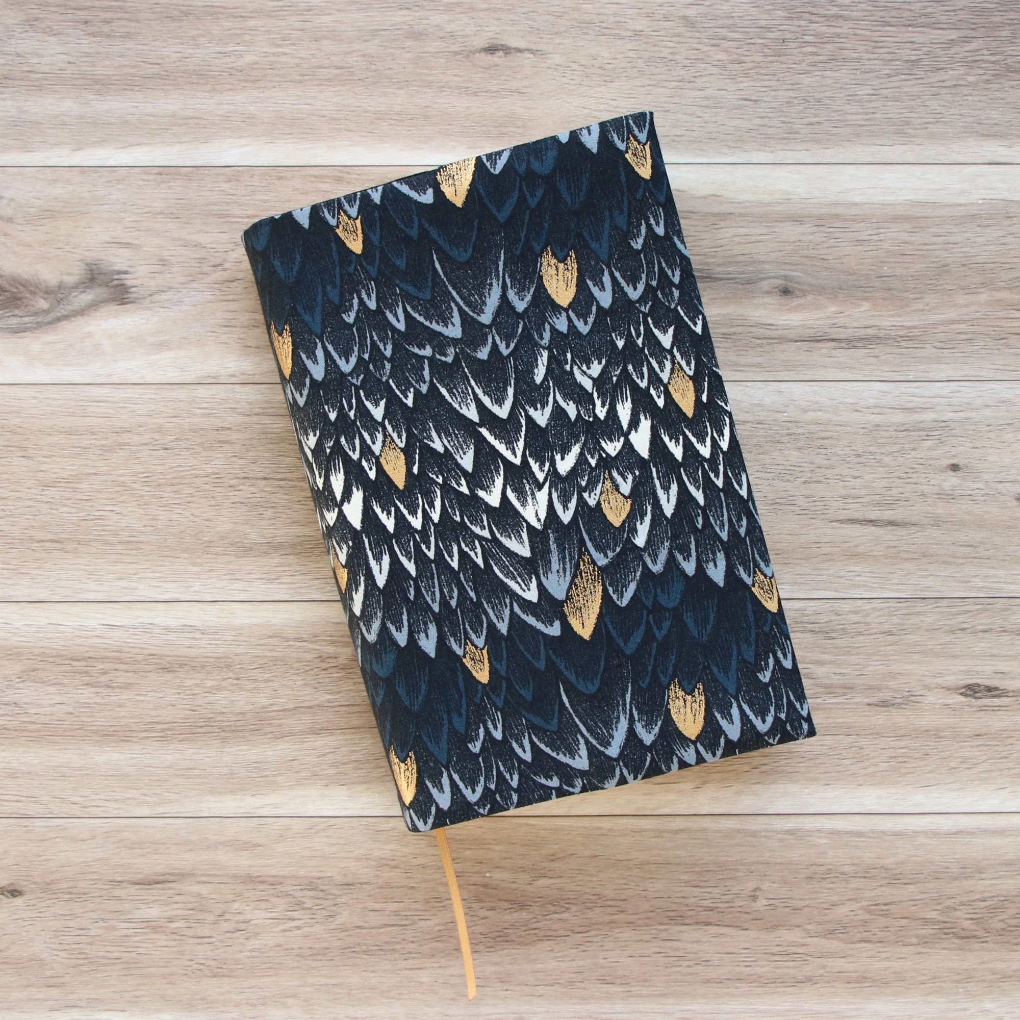 Adjustable First Edition Book Jacket showing built-in ribbon bookmark and protective fabric cover.