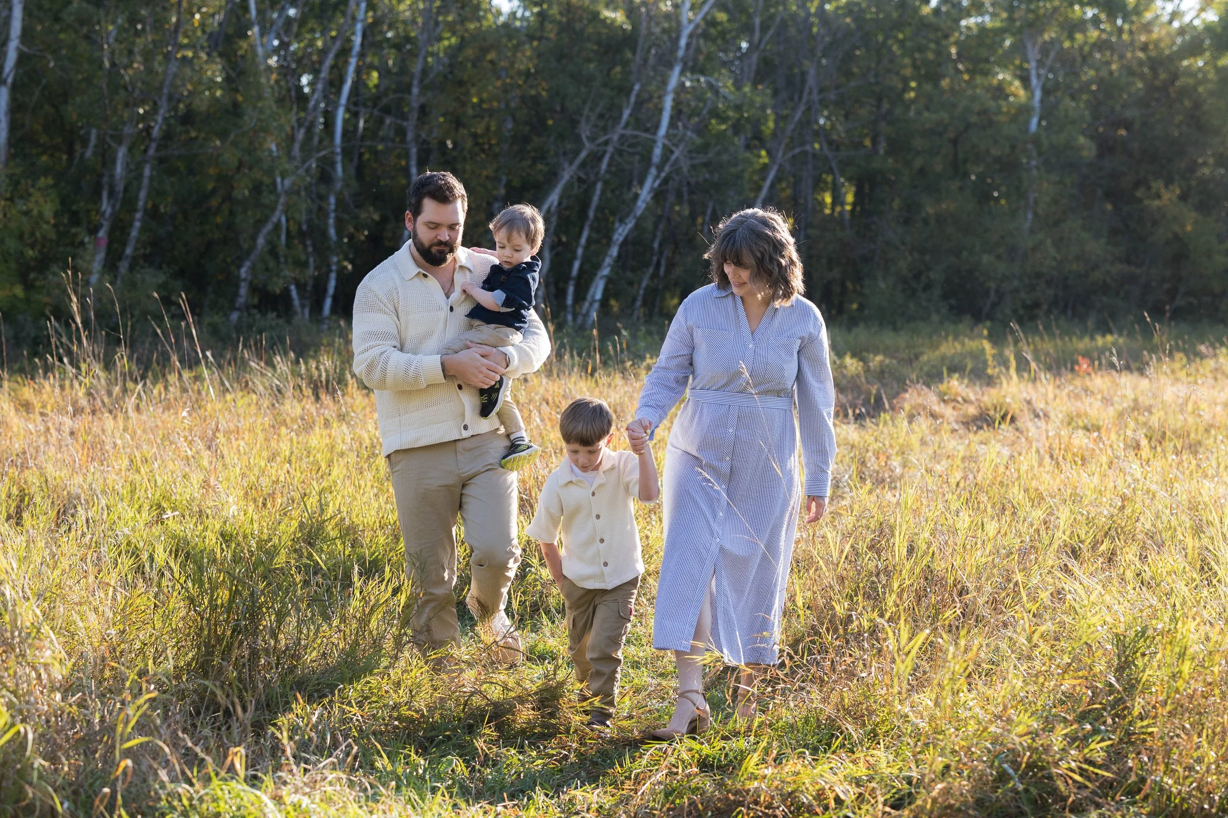 Family walking in at Assiniboine Forest for a photoshoot in the fall