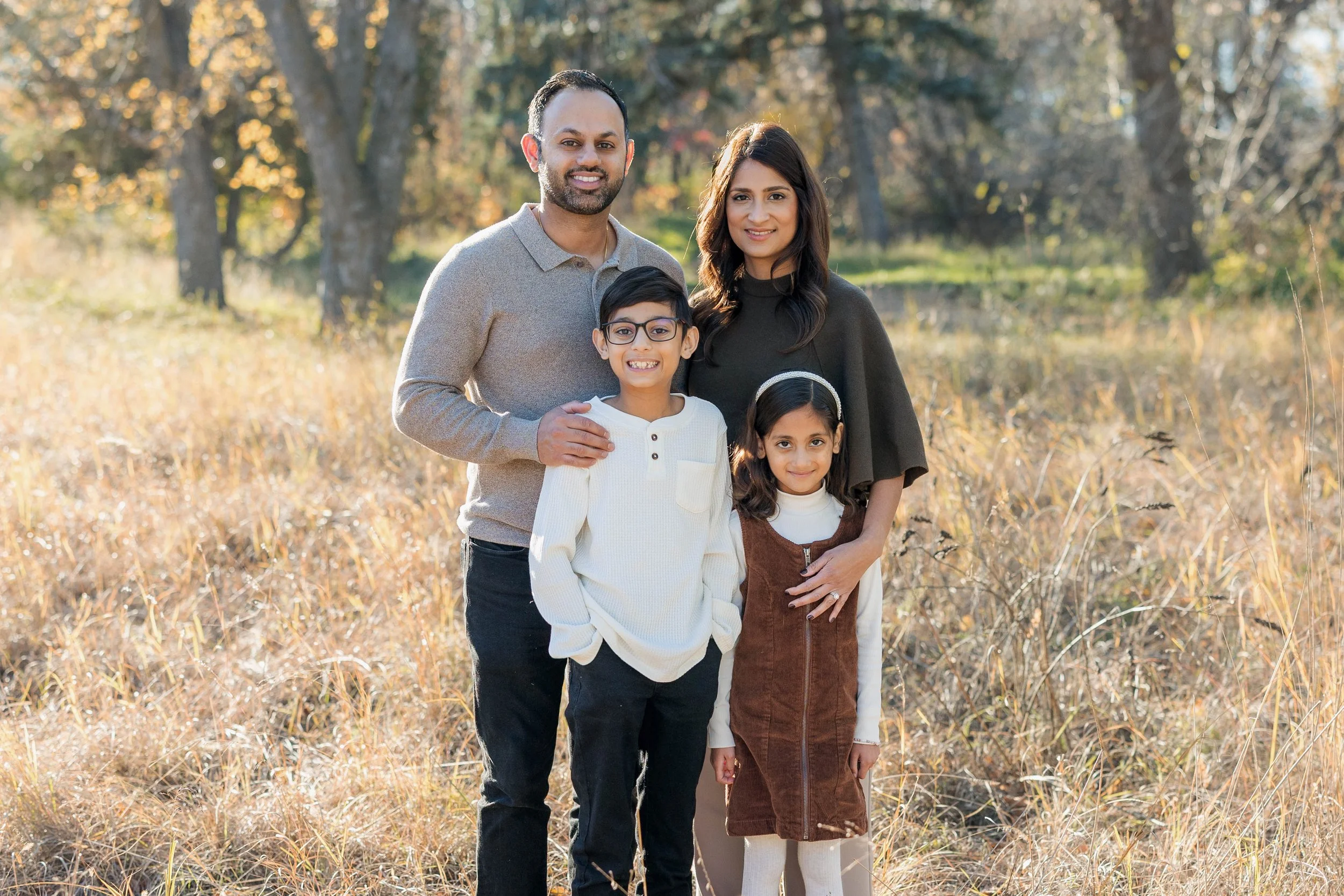 Family on Wellington Crescent, Winnipeg, having photos done in the fall