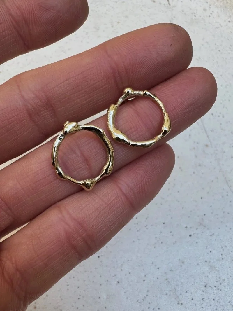 Minimalist gold hoop earrings with bold organic shape