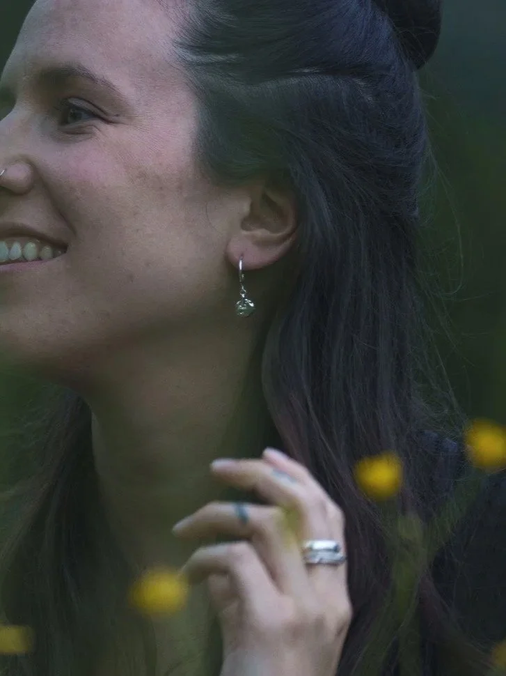 Artisan handmade earrings with small hoops and textured round pendant for wild expressive organic women