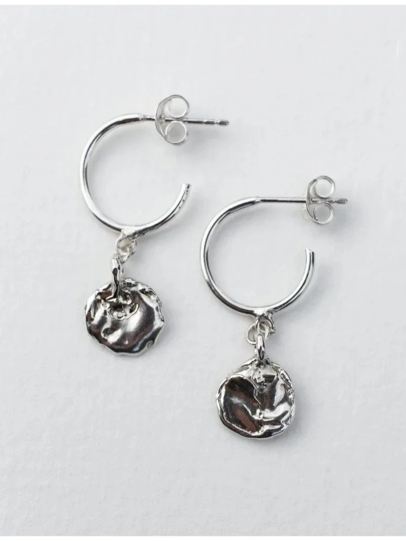 Handmade modern hoop earrings with organic textured pendant in recycled silver for wild expressive women