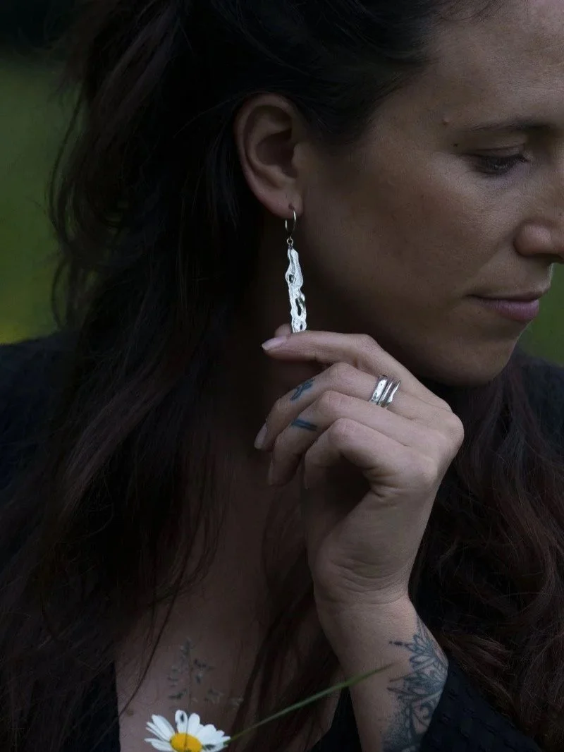 Organic silver earrings handcrafted from recycled sterling silver with a fluid liquid-like texture.