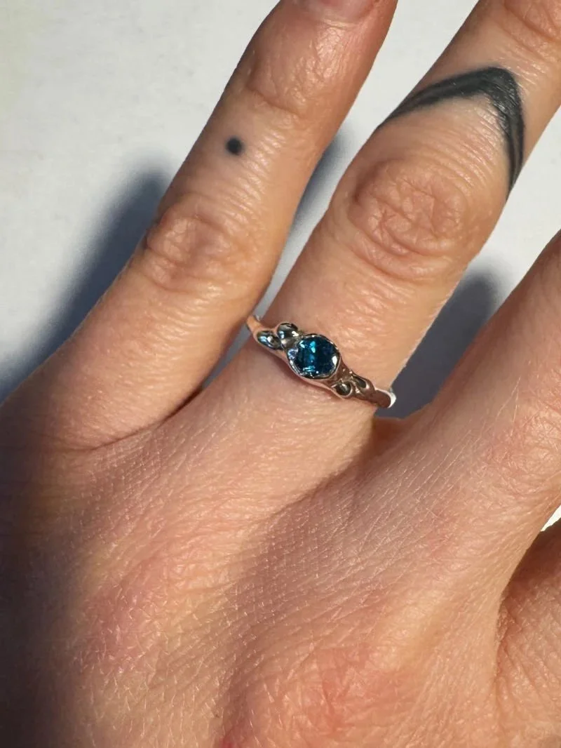 Modern and alternative ring made from recycled silver with a London blue topaz gemstone