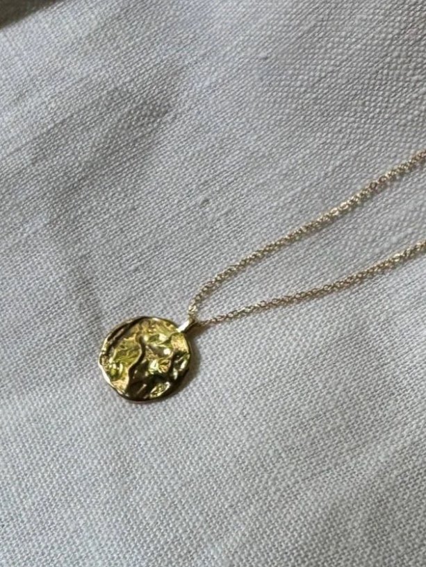 Handcrafted moon charm necklace in recycled gold, a modern fine jewellery piece with timeless celestial beauty and soulful design.