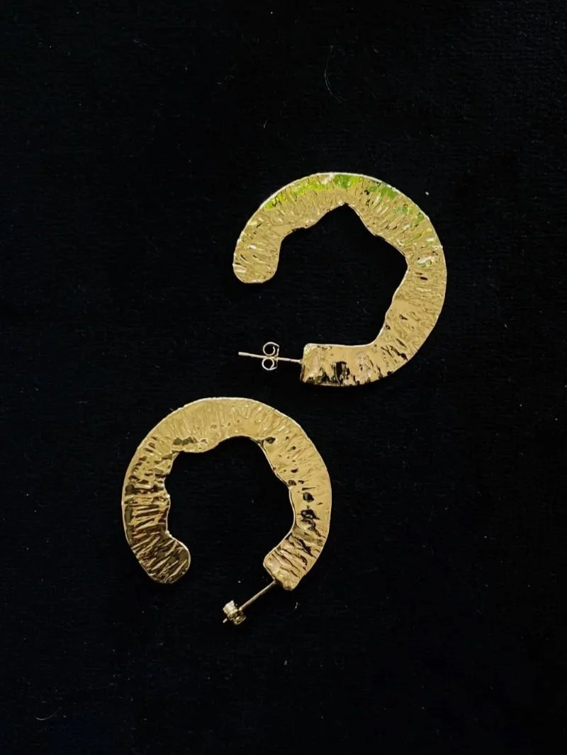 Handmade gold statement earrings with a large circular shape, lightweight feel and expressive modern design for timeless styling.