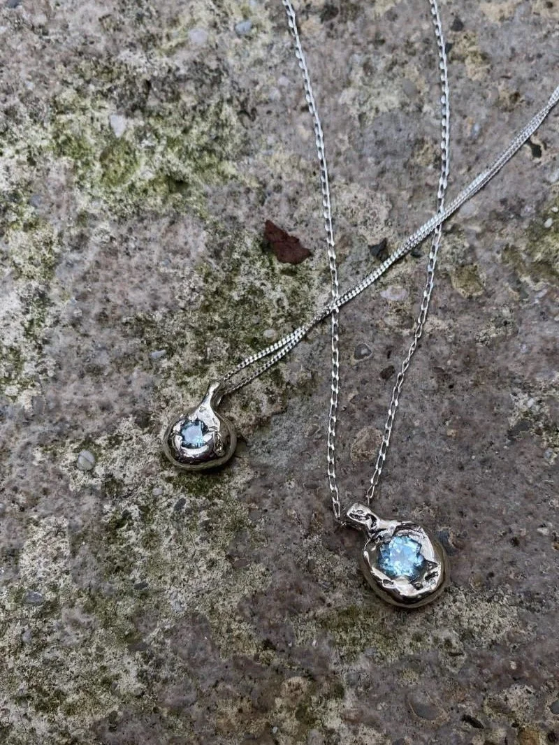 Feminine silver necklace with a topaz gemstone made from recycled silver.