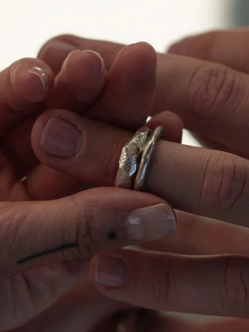 Bold men’s sterling silver ring with a wide band, irregular silhouette and engraved texture, handcrafted in a modern organic style.