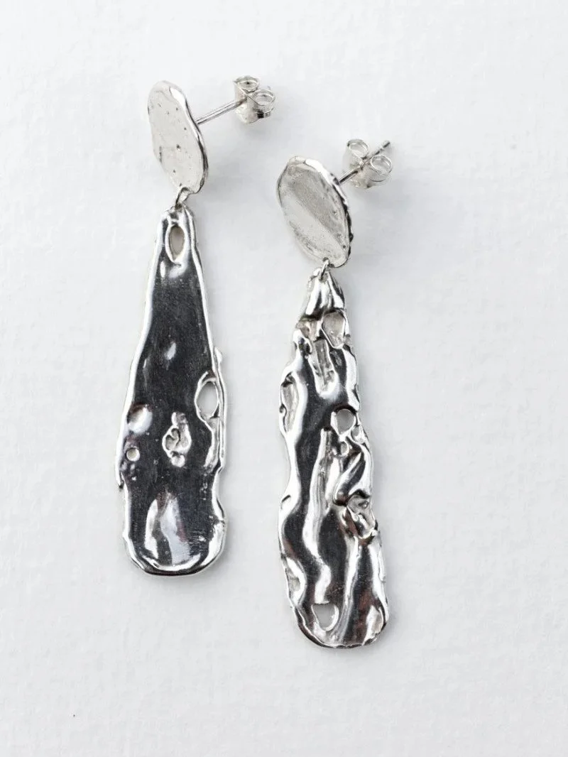 Handmade recycled sterling silver earrings with organic texture inspired by the moon surface.