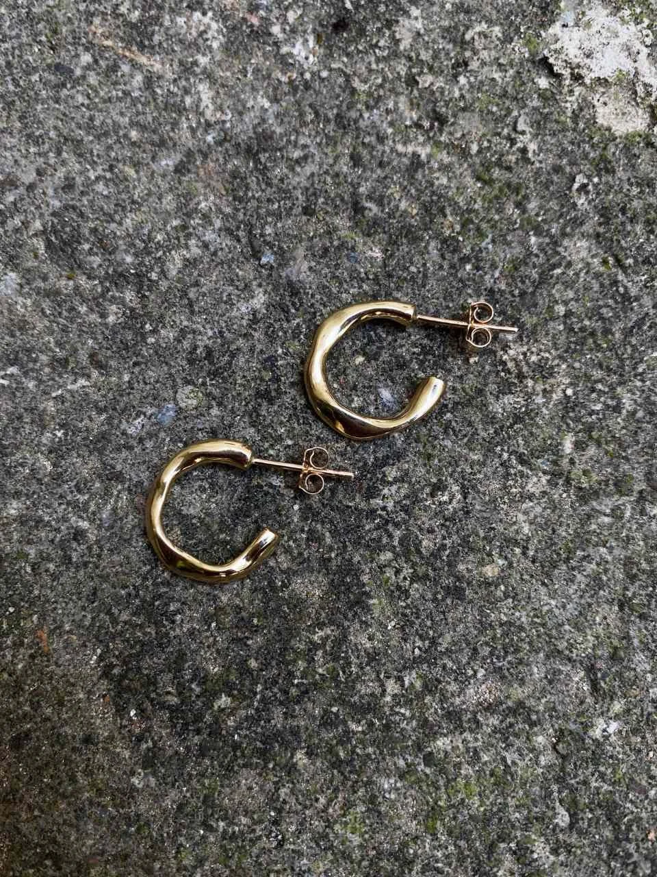 Organic gold earrings in a small minimalist size, featuring handmade texture and a unique wabi-sabi inspired design.