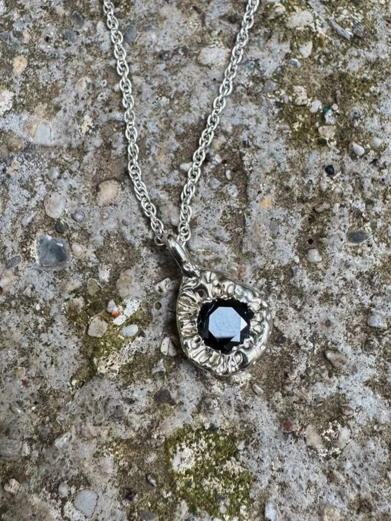 Artisan sapphire pendant necklace with dark blue gemstone, handcrafted in recycled silver or gold for lovers of modern organic jewellery.