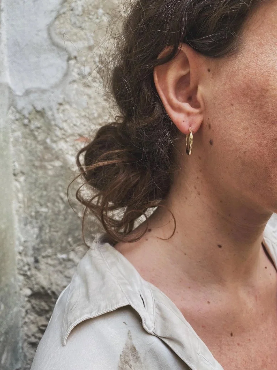 Sculptural artisan earrings with soft irregular curves, handmade in recycled silver or gold for timeless everyday wear.