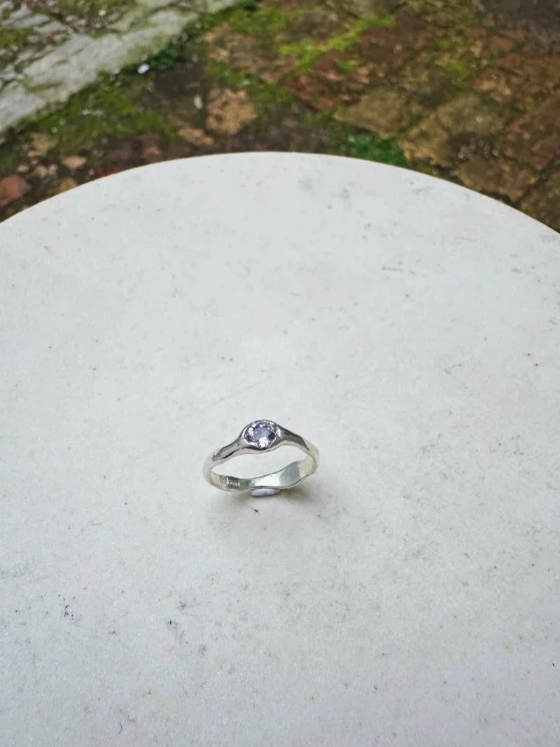 Handmade amethyst ring in recycled 925 sterling silver with a 5mm light purple gemstone, organic band and raw wabi-sabi texture.