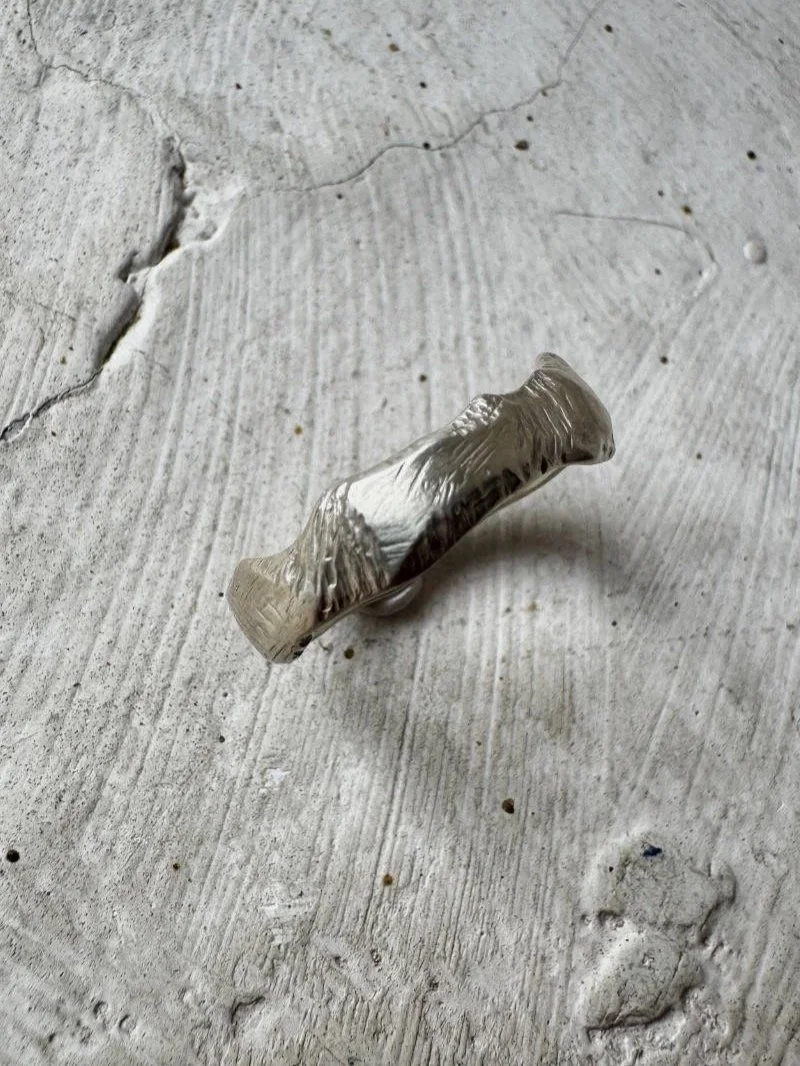 Raw and modern recycled silver ring with sculptural curves, organic form and handmade artisanal character.