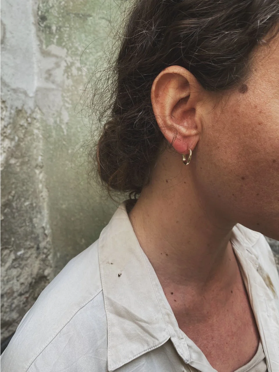 Small gold hoop earrings with an earthy wabi-sabi texture, handcrafted in recycled 14ct or 18ct gold.